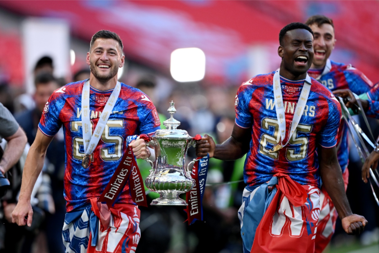 Marc Guehi celebrates winning the FA Cup with Crystal Palace in May
