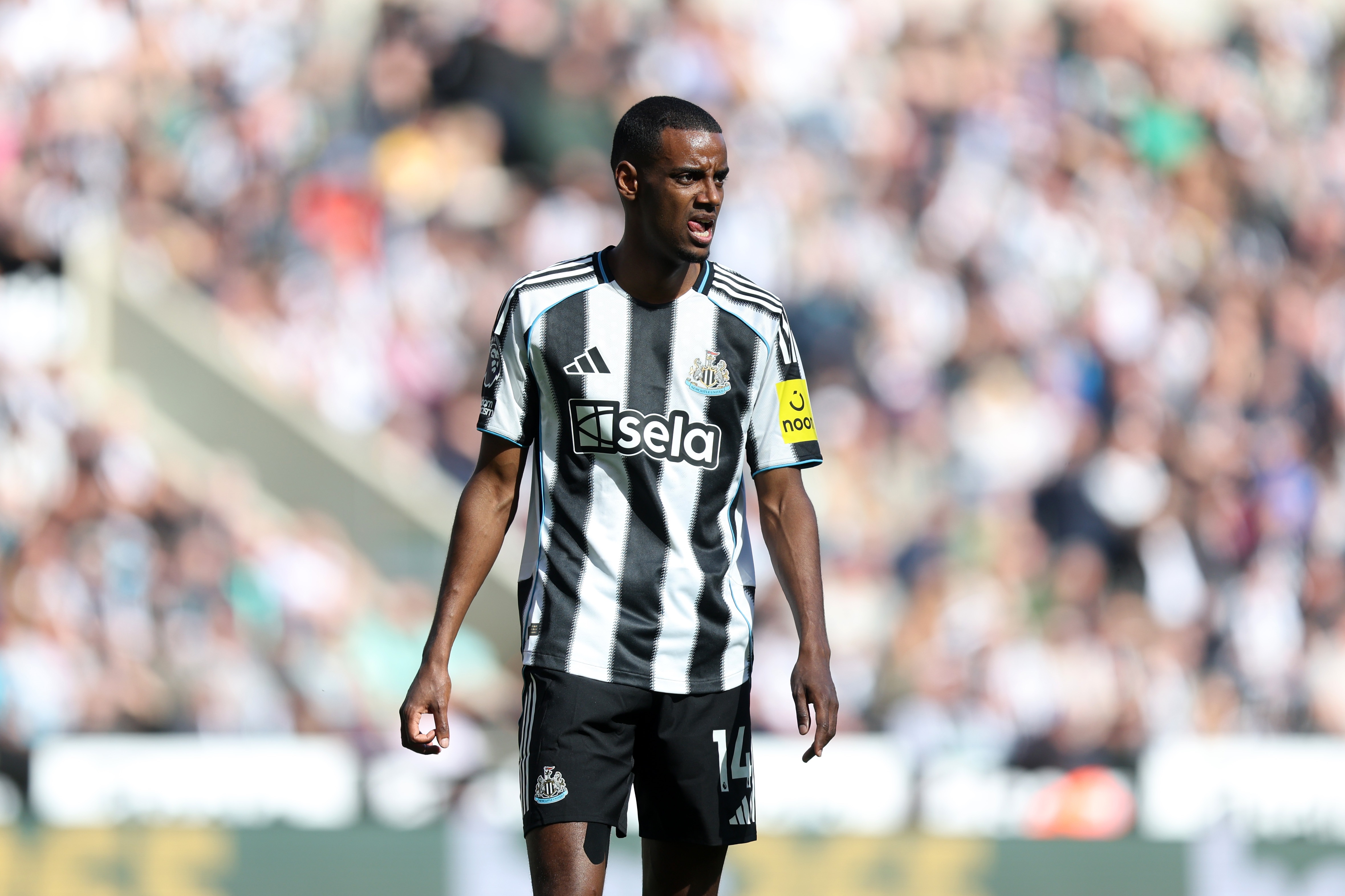 Alexander Isak licks hips lips whilst standing during Newcastle game.