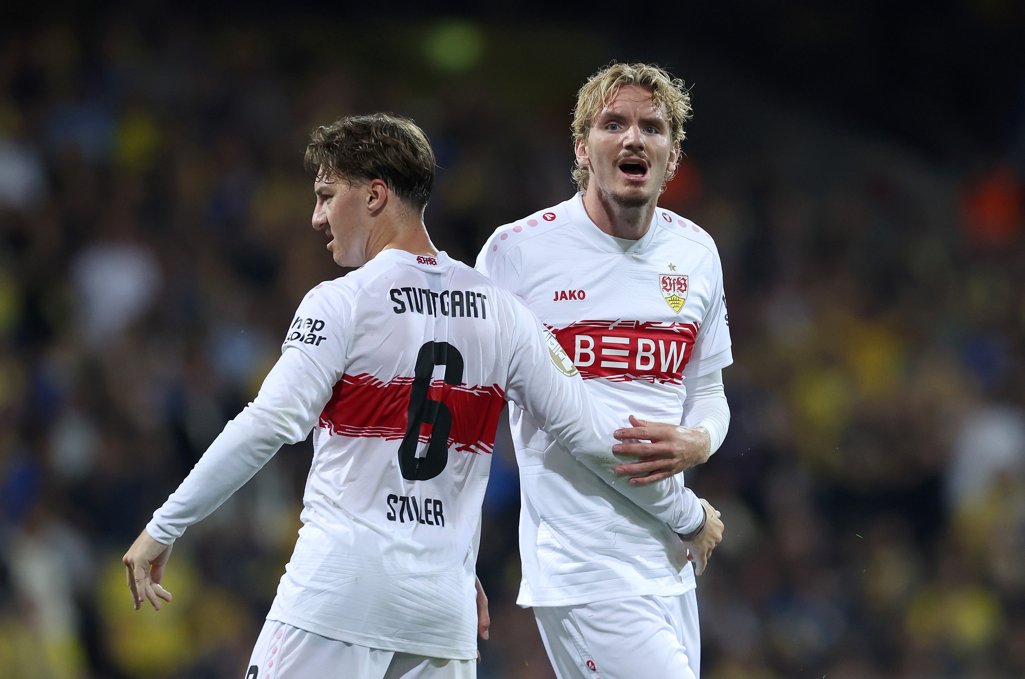 Nick Woltemade embraces Angelo Stiller during Stuttgart game.
