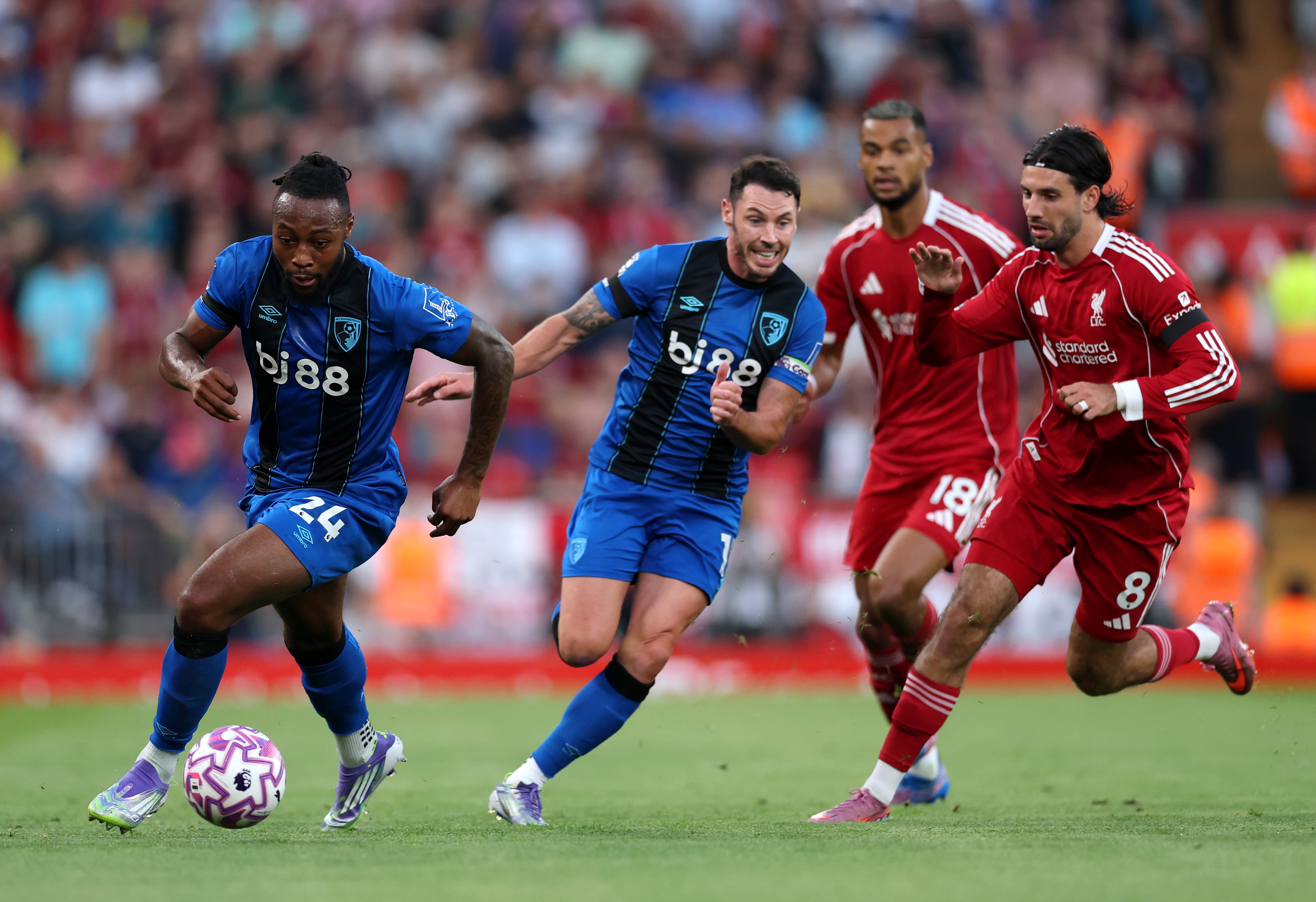 Antoine Semenyo dribbles past Liverpool midfielder Szoboszlai.