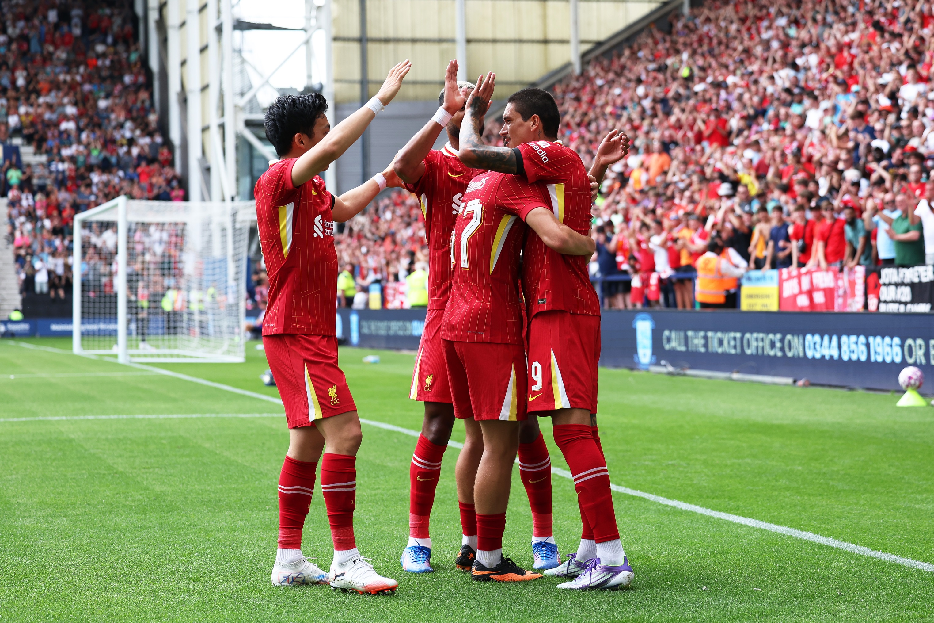 Darwin Nunez hugs teammates during Liverpool game.