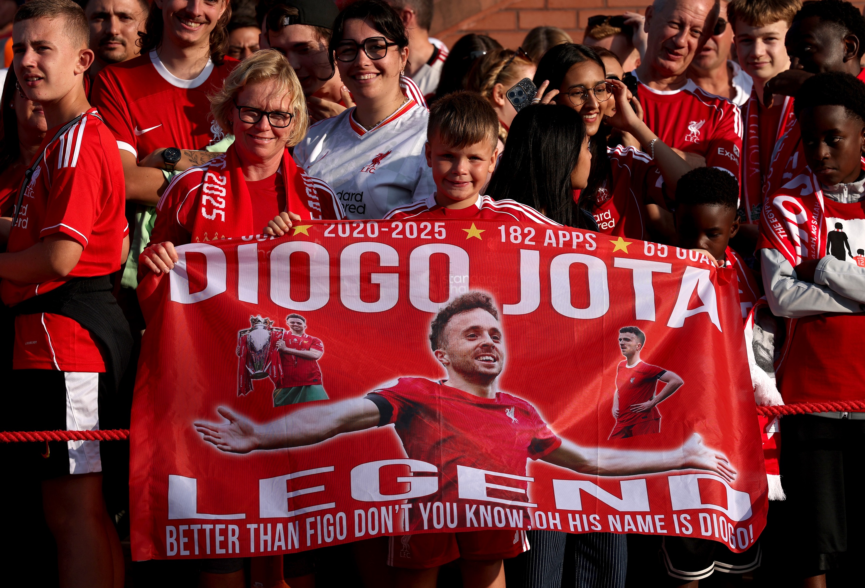 Liverpool fans hold up a banner with Diogo Jota.
