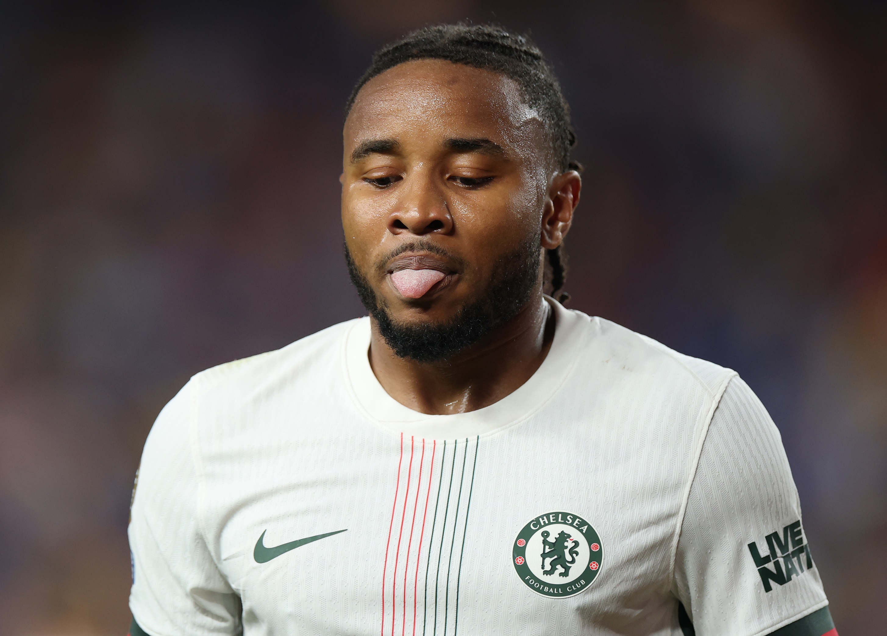 Christopher Nkunku sticks out his tongue during Chelsea game.