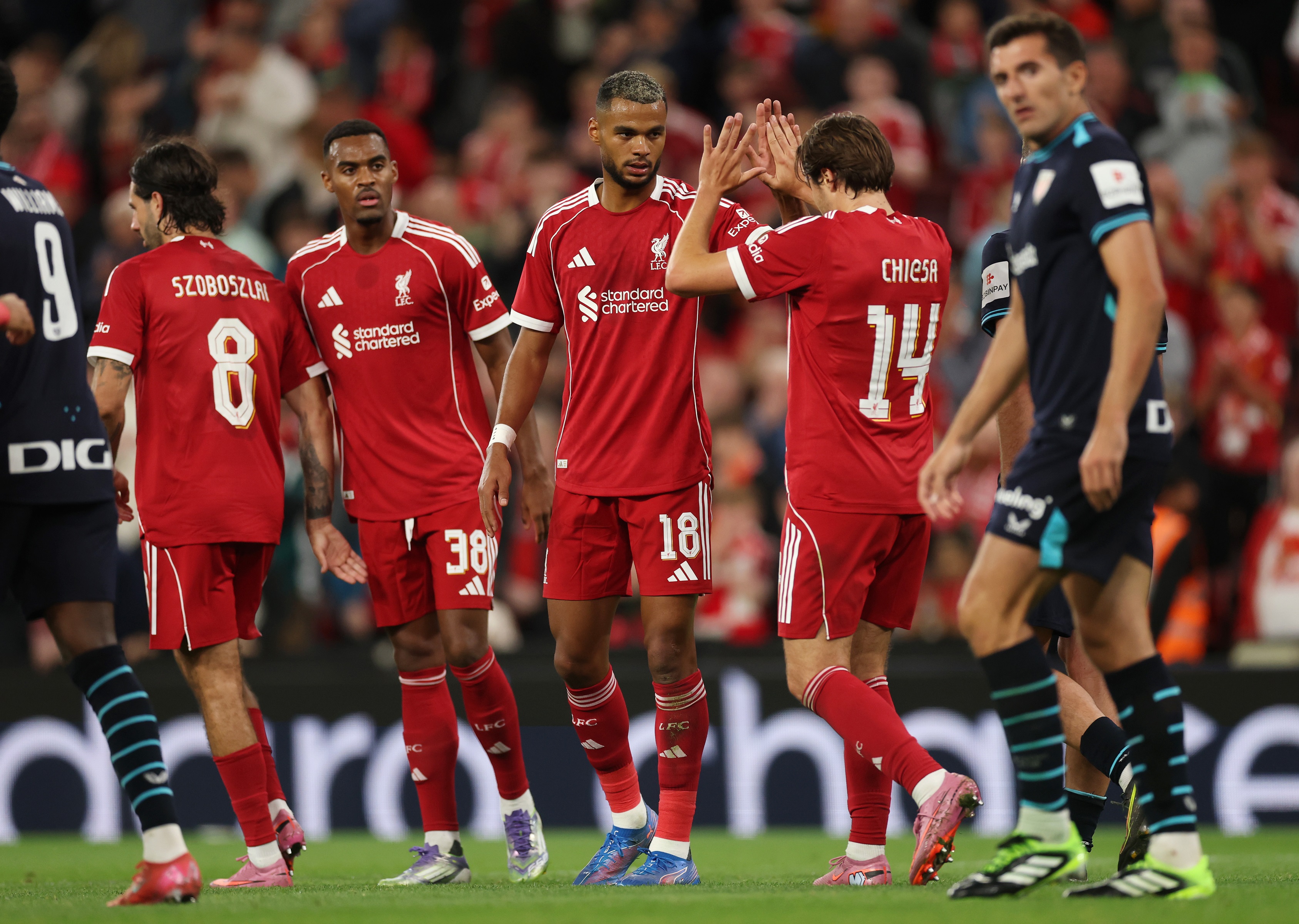 Federico Chiesa high fives Liverpool teammate Cody Gakpo.