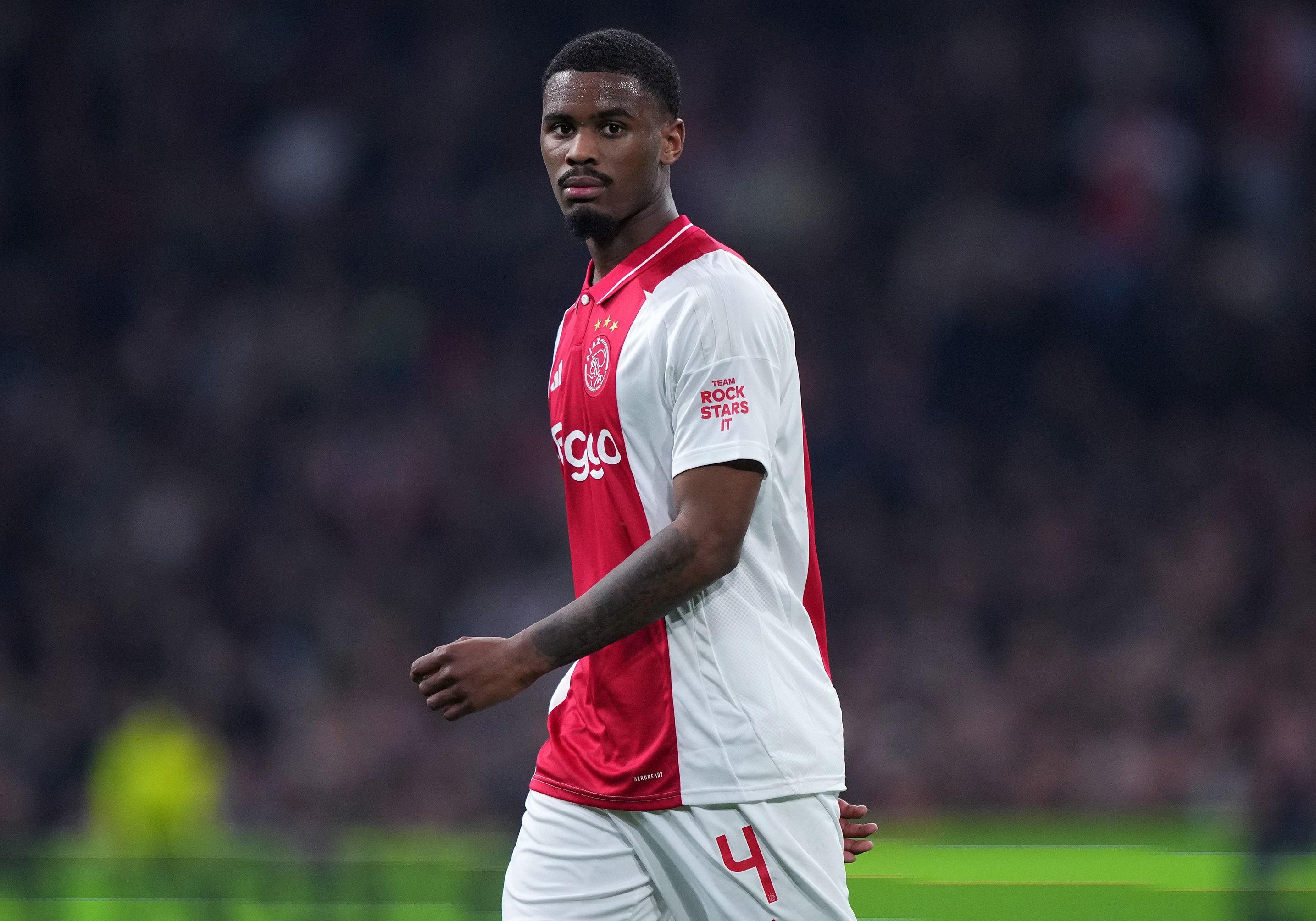 Jorrel Hato walks on the pitch during Ajax game.