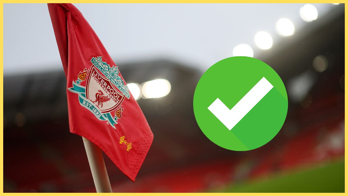 Liverpool flag flaps in the wind next to green check mark.