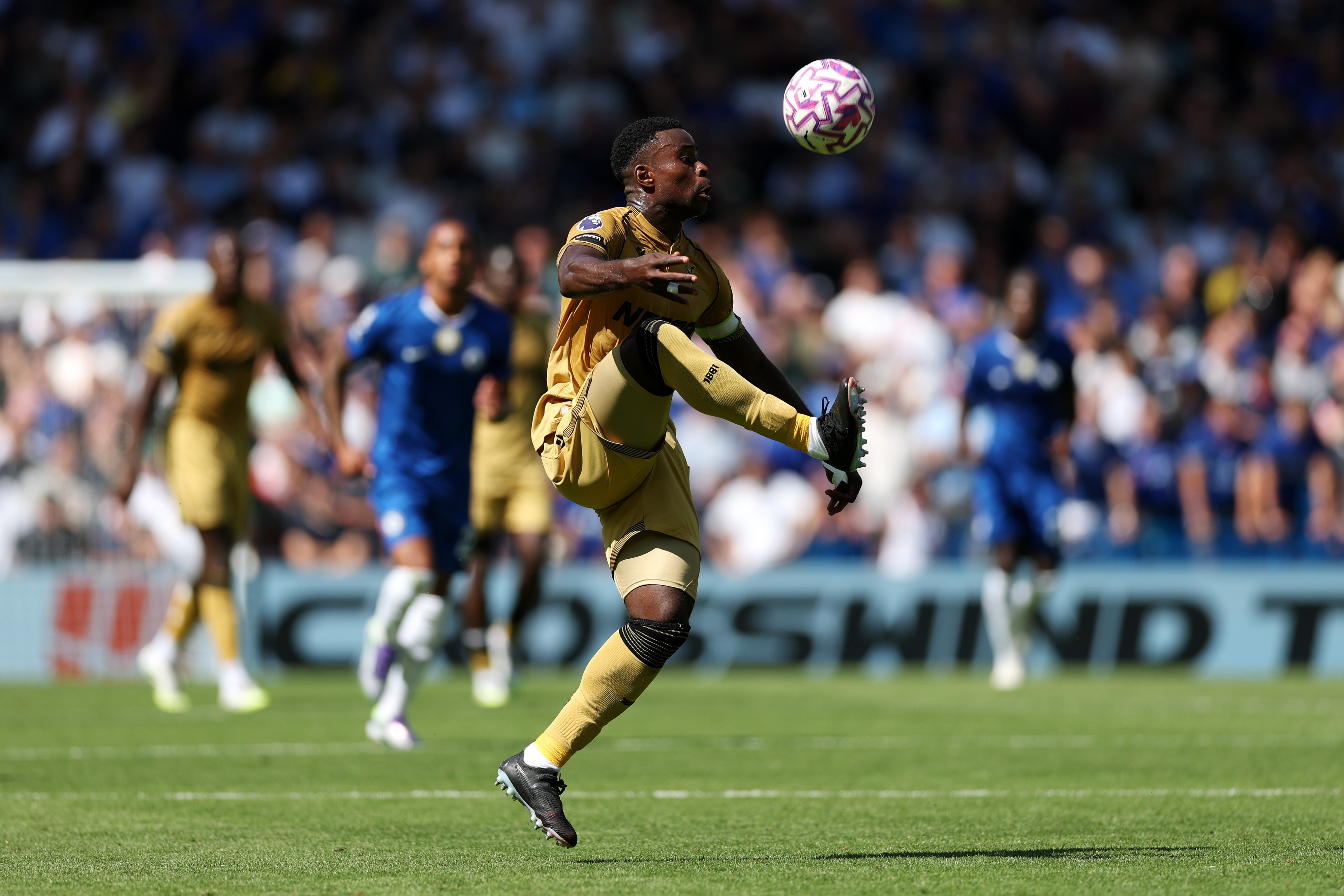 Marc Guehi lifts his right leg to control a ball in mid-air.