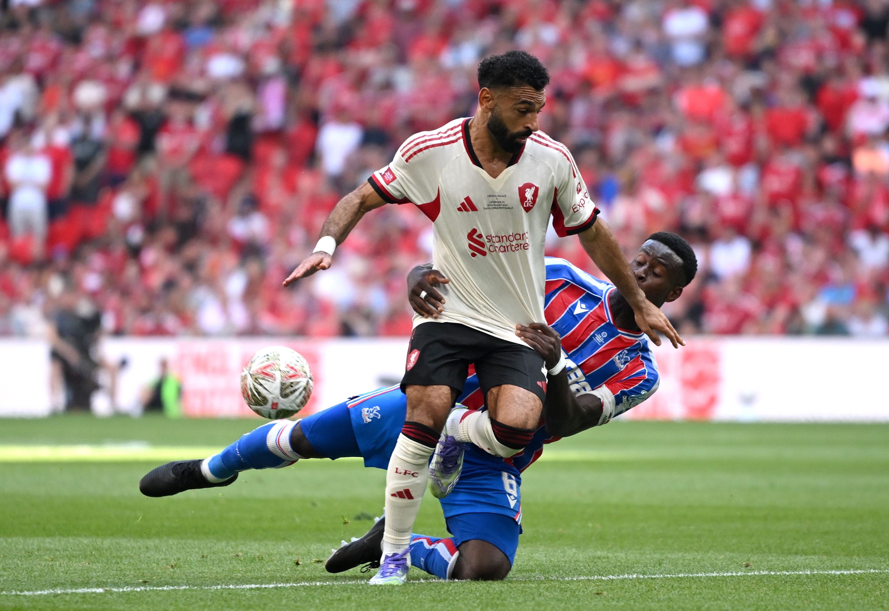 Marc Guehi grabs Mo Salah as he falls to the turf.