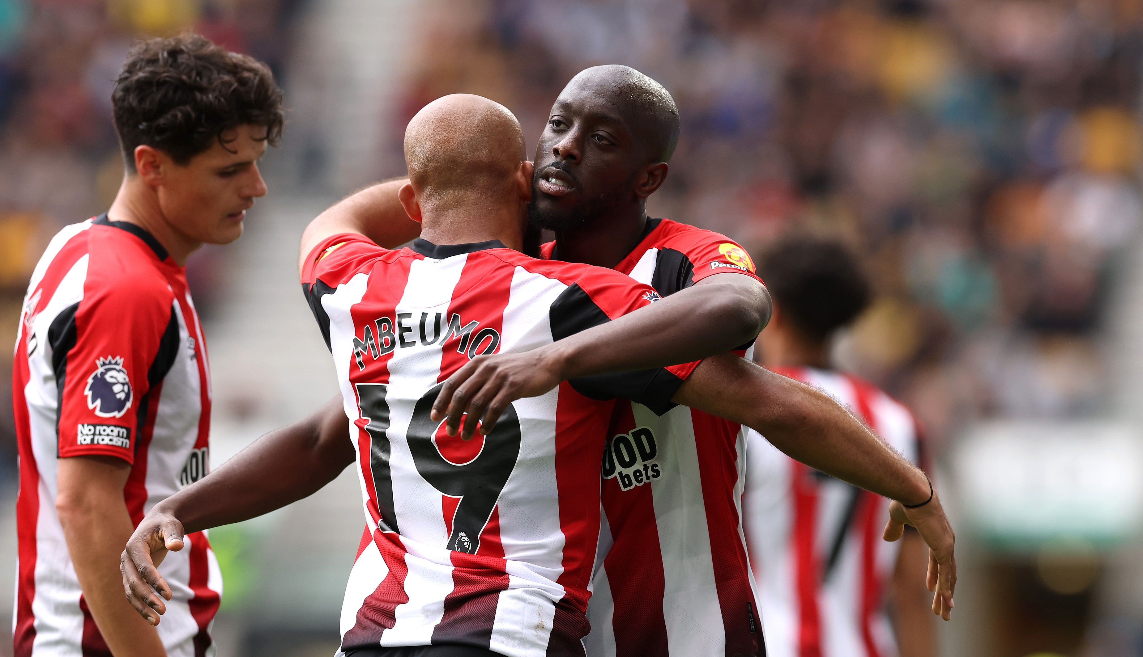 Yoane Wissa hugs Bryan Mbeumo during Brentford game.