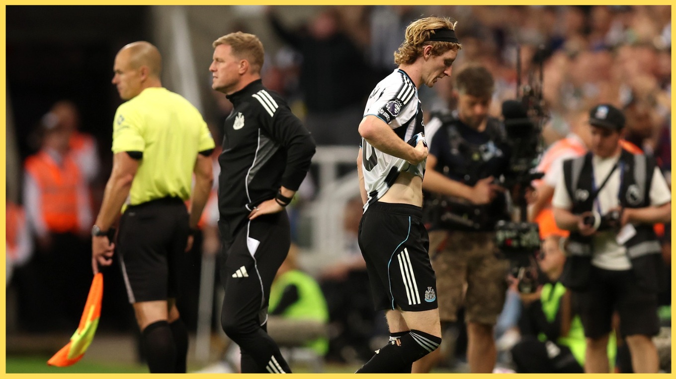 Anthony Gordon leaves the pitch after his red card against Liverpool
