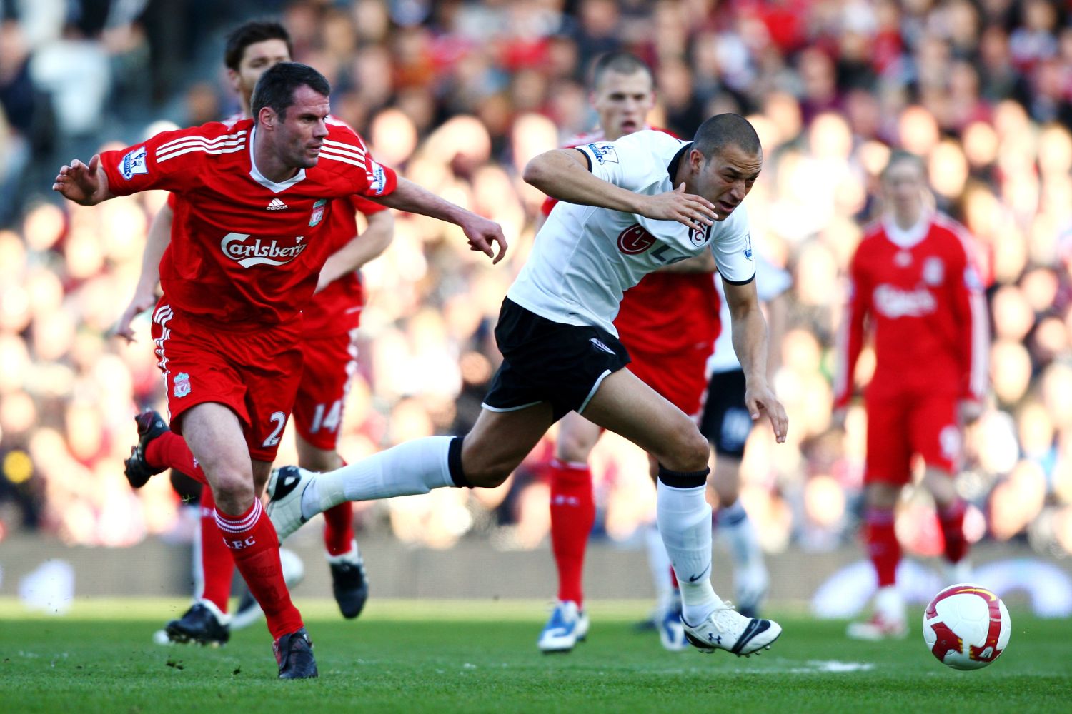 Bobby Zamora plays against Jamie Carragher of Liverpool
