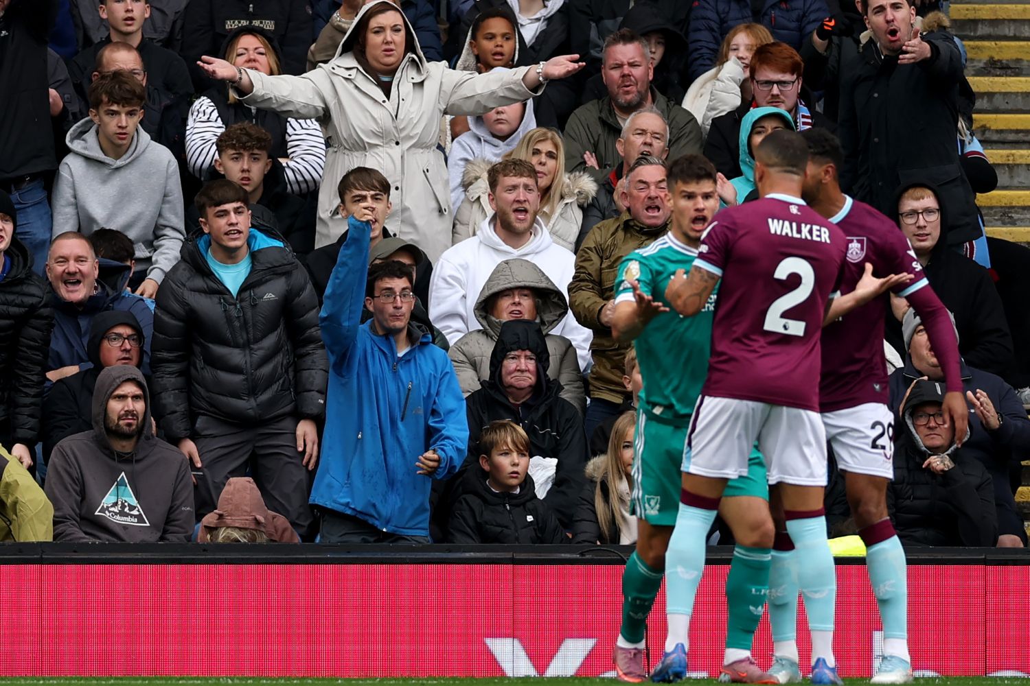Burnley fans react after Milos Kerkez of Liverpool is yellow carded for simulation