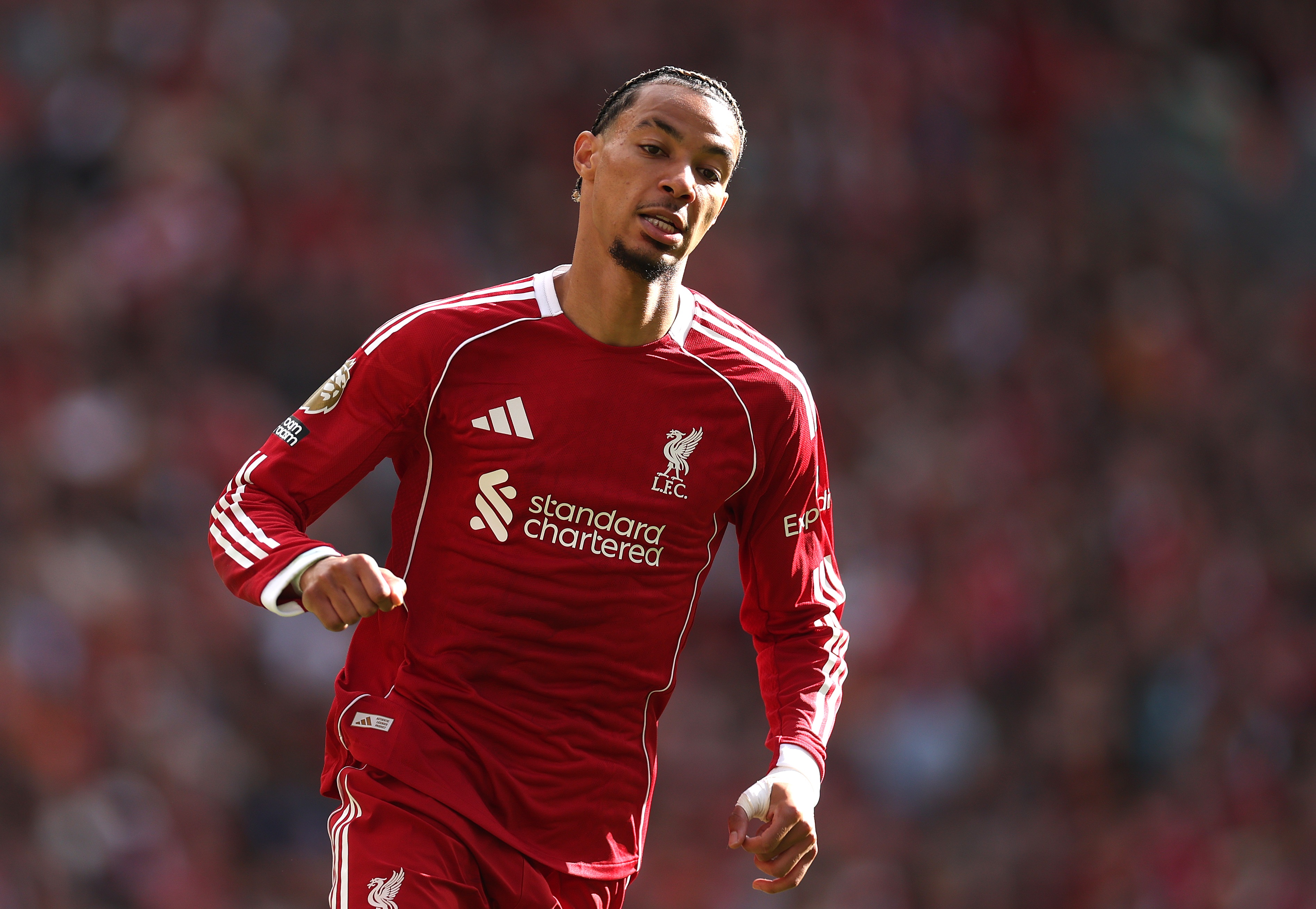 Hugo Ekitike runs on the pitch in the Liverpool home shirt.