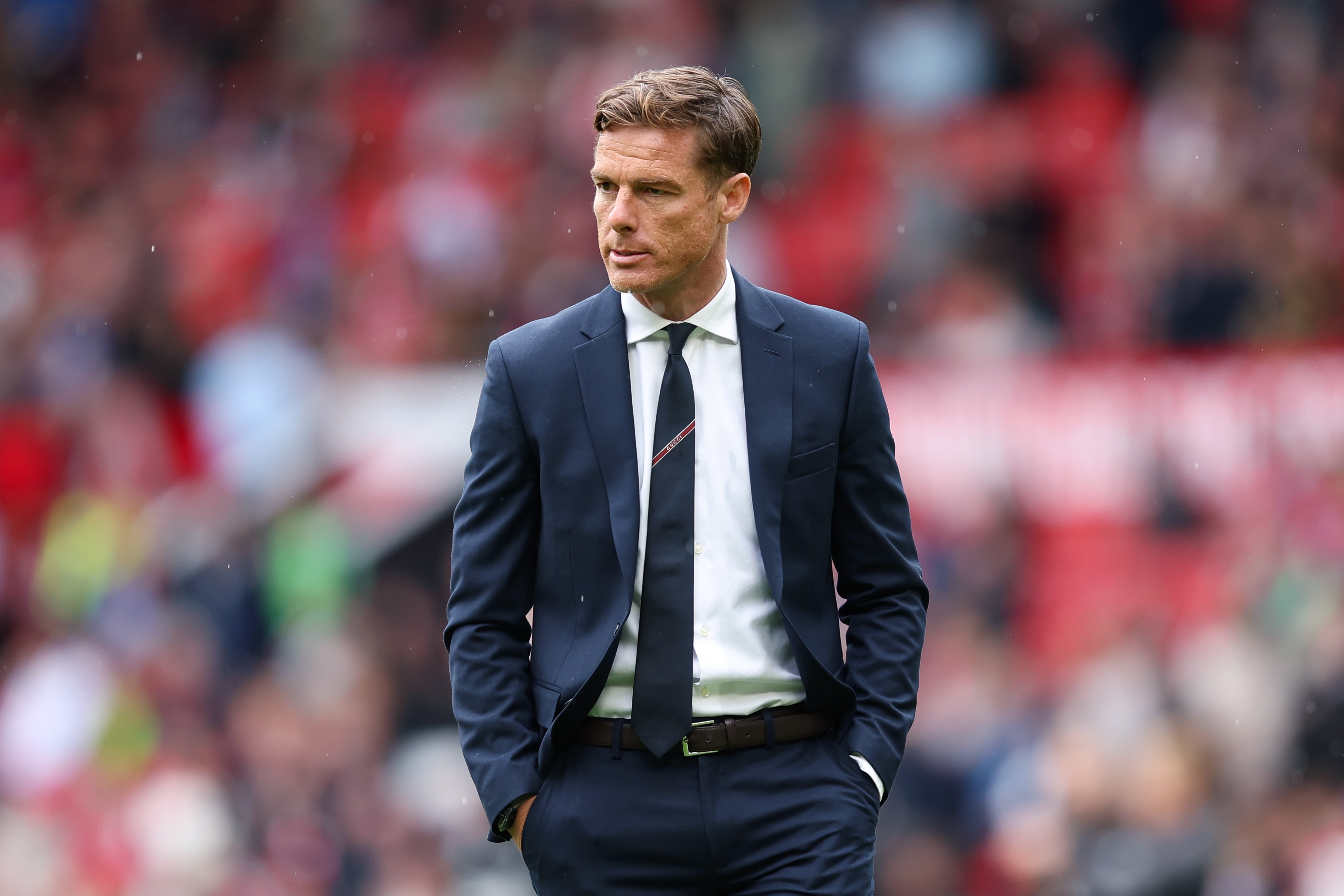 Burnley manager Scott Parker looks on with his hands in his pockets.
