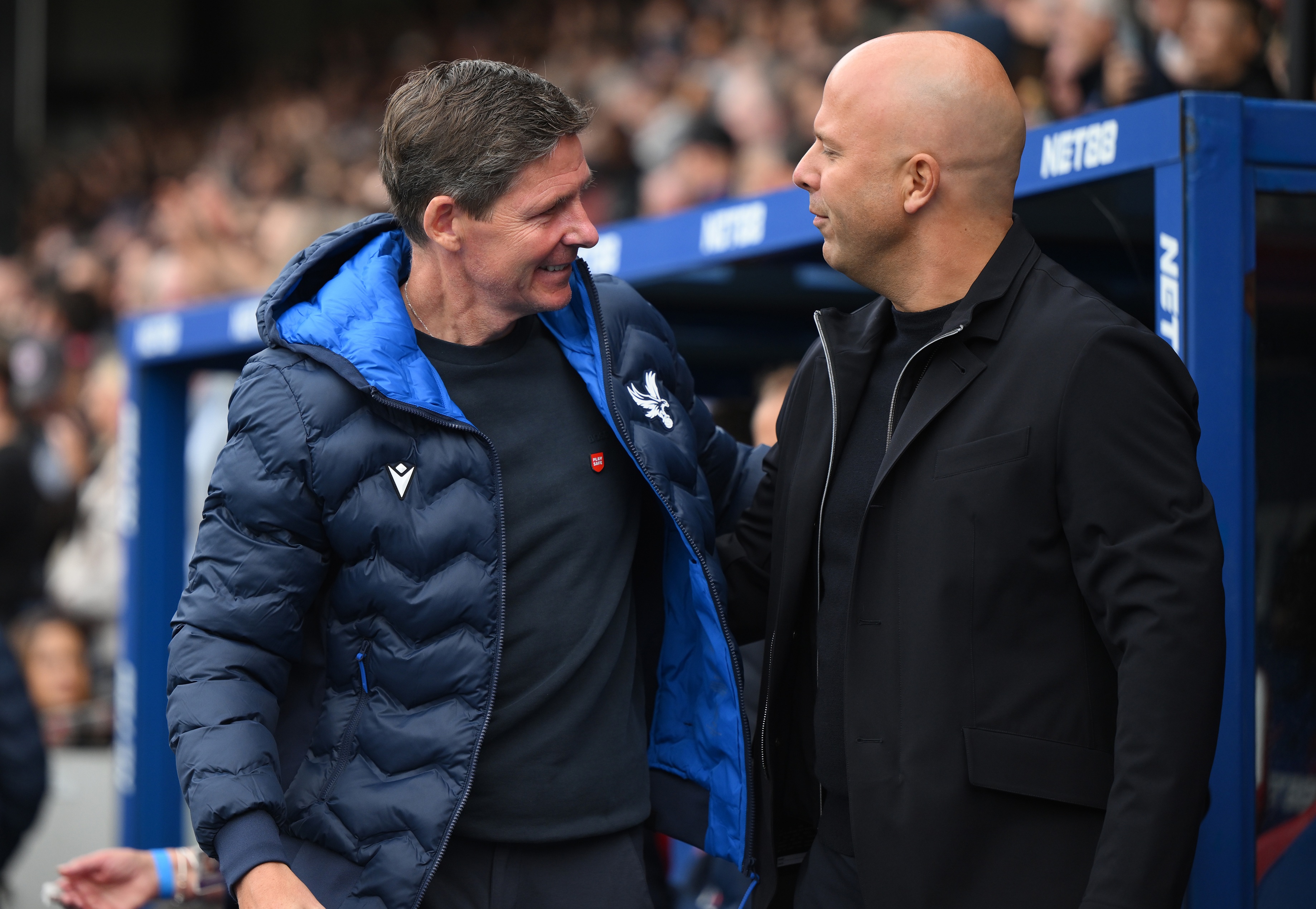 Arne Slot embraces Crystal Palace manager Oliver Glasner on the touchline.