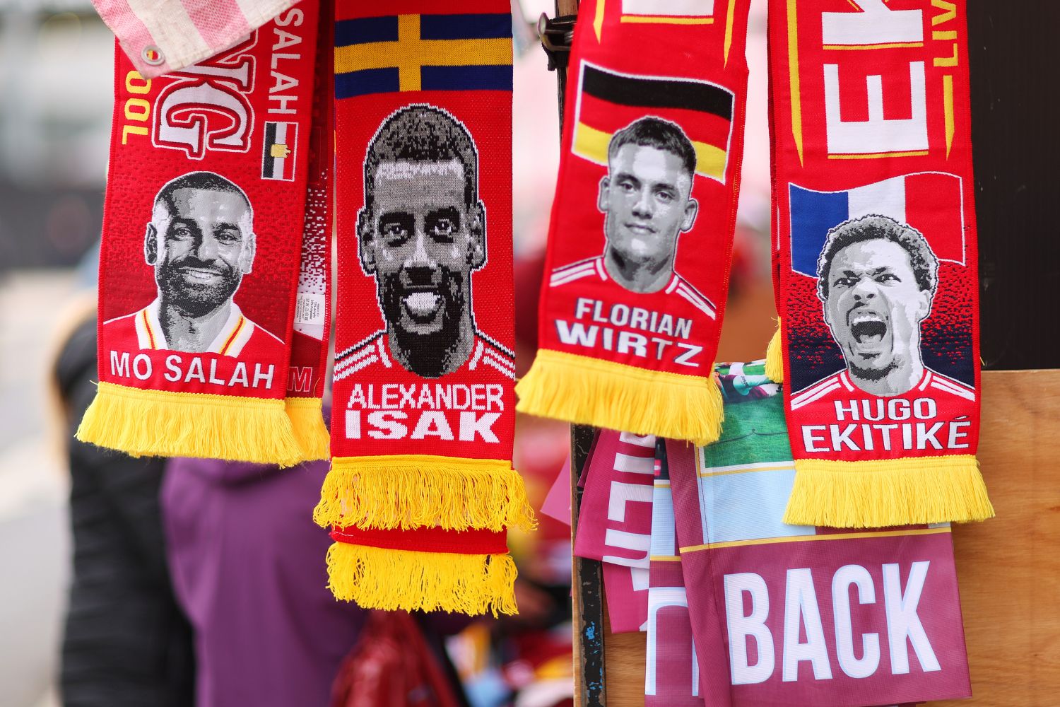 scarves, featuring the faces of Mohamed Salah, Alexander Isak, Florian Wirtz and Hugo Ekitike
