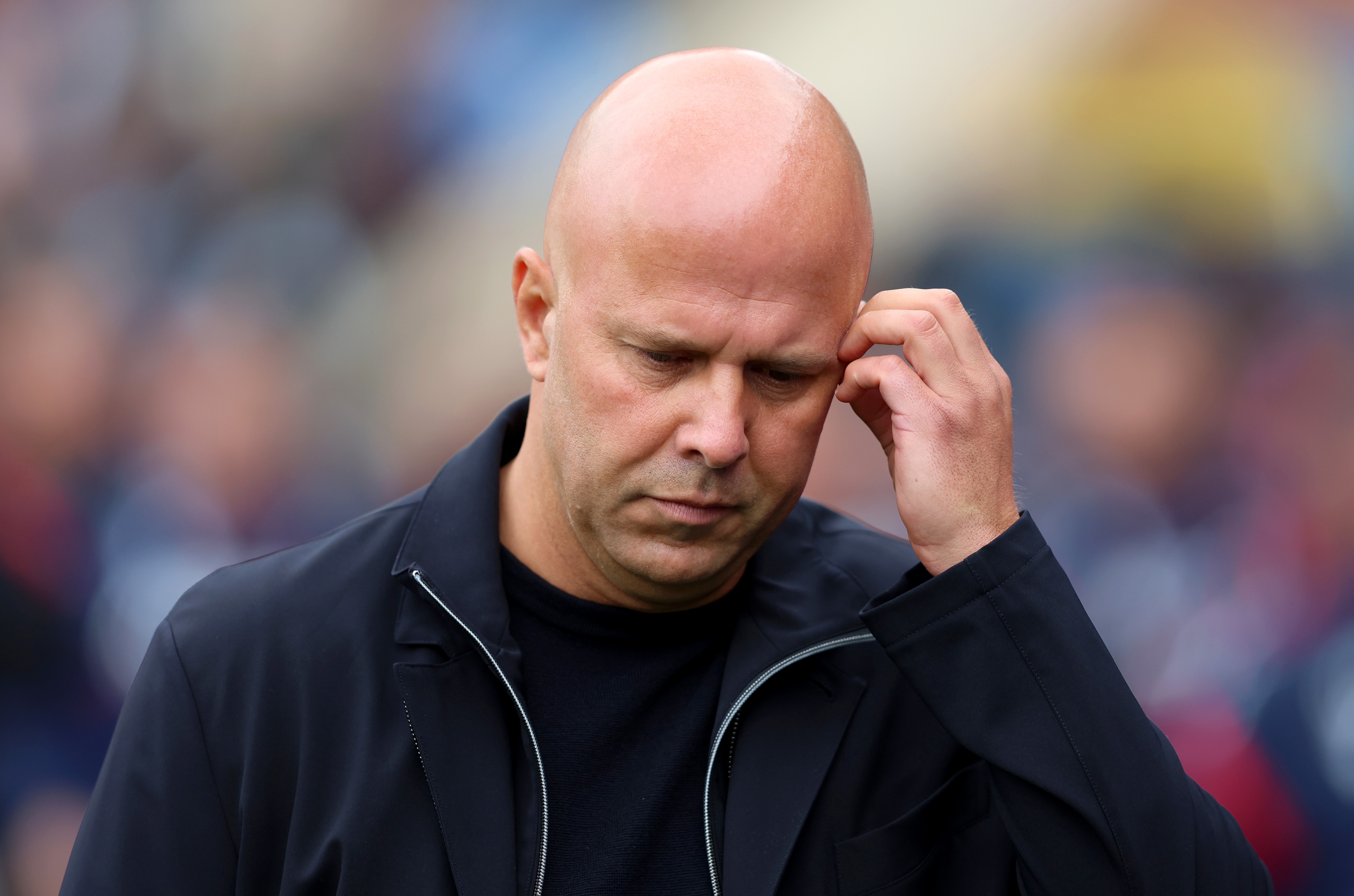 Liverpool head coach Arne Slot scratches his head.