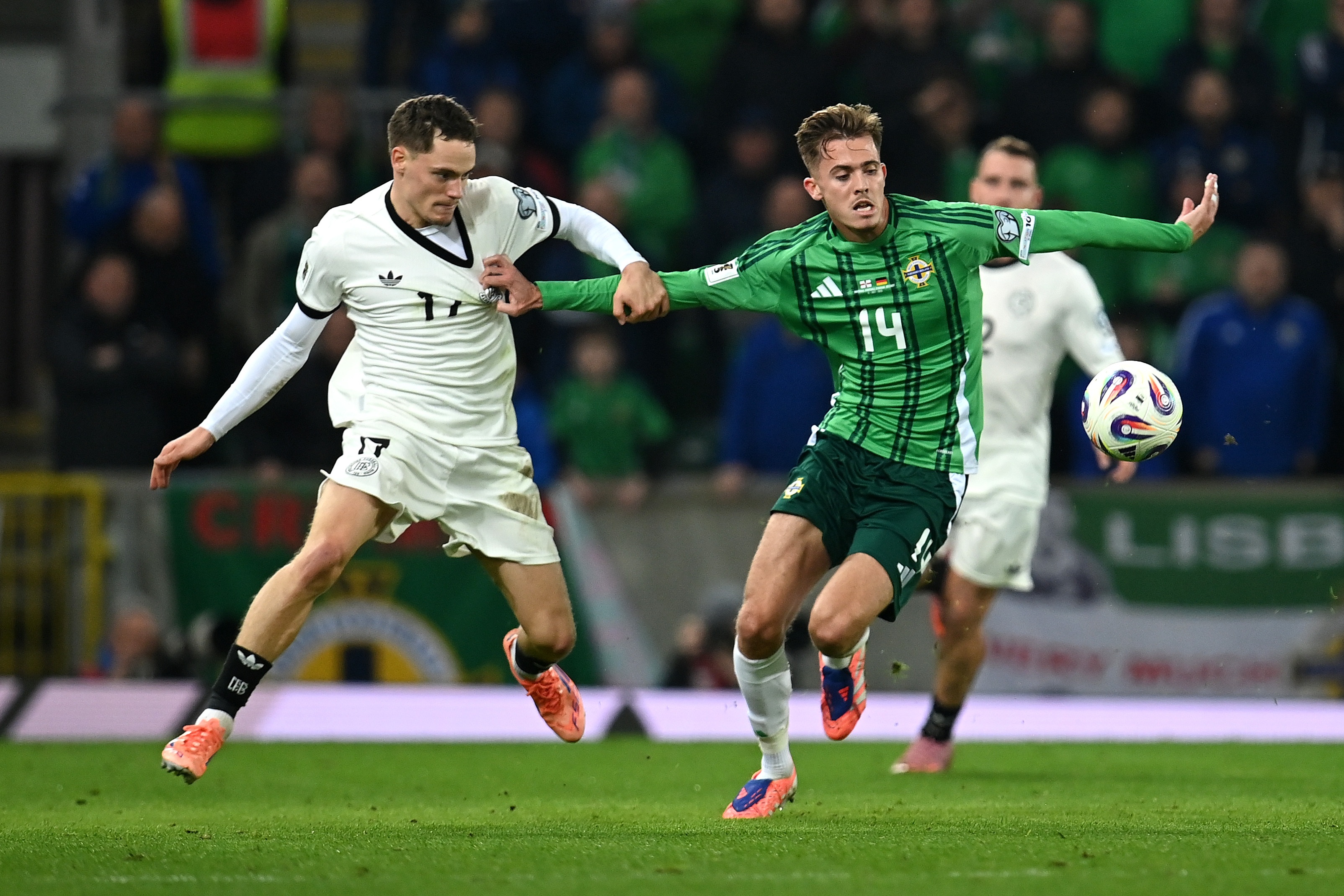 Isaac Price grabs Florian Wirtz's shirt whilst under pressure.
