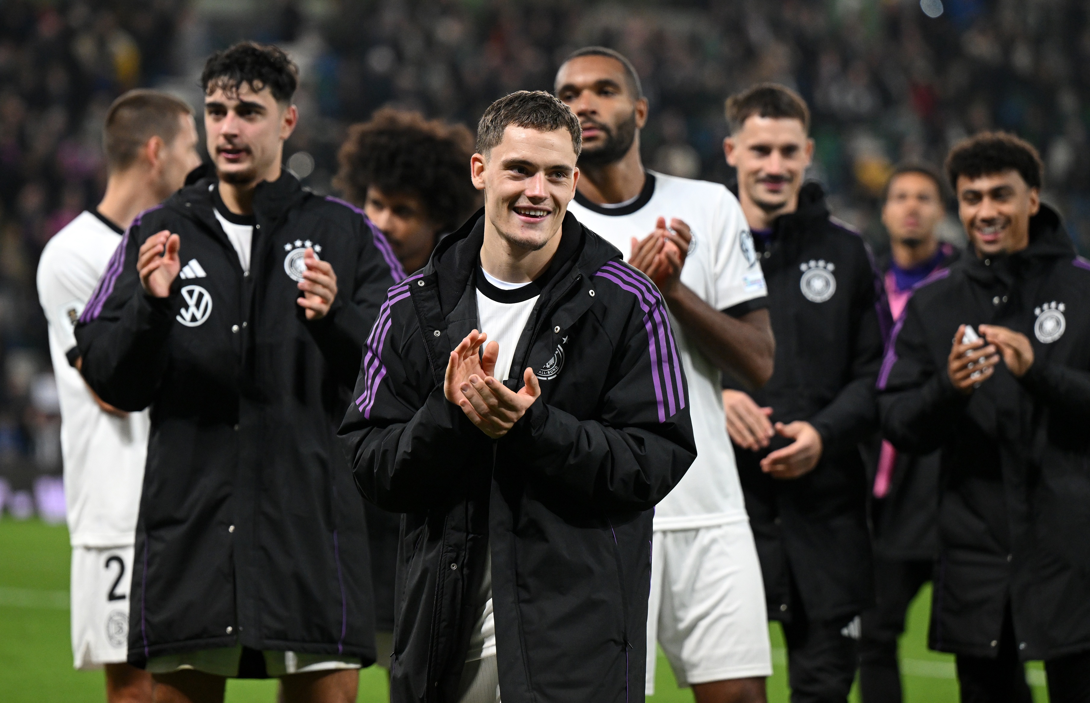 Florian Wirtz and Germany teammates clap their hands after full-time.
