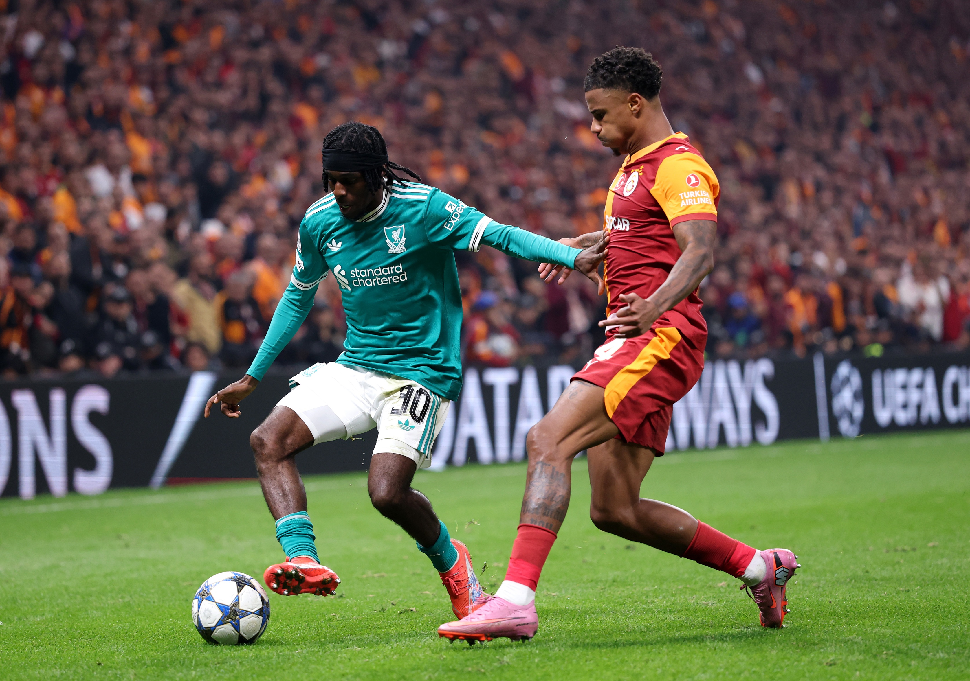 Jeremie Frimpong holds off Ismail Jakobs whilst controlling the ball.