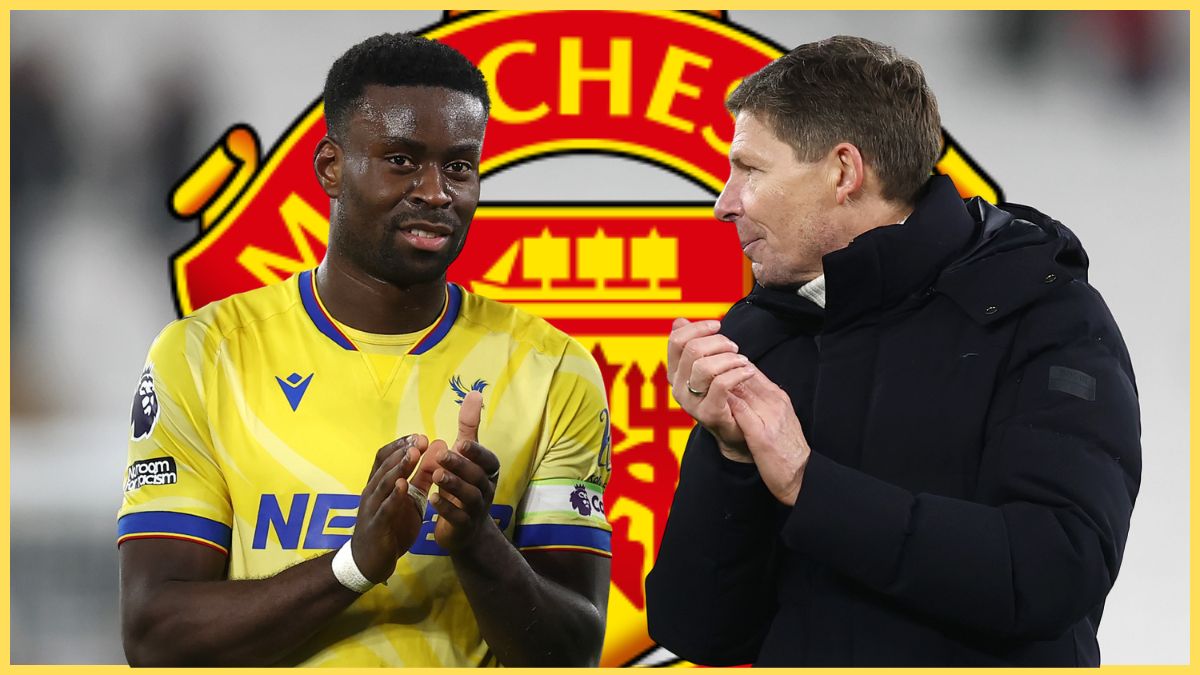 Marc Guehi claps his hands whilst standing next to Oliver Glasner with the Manchester United club crest in the background.