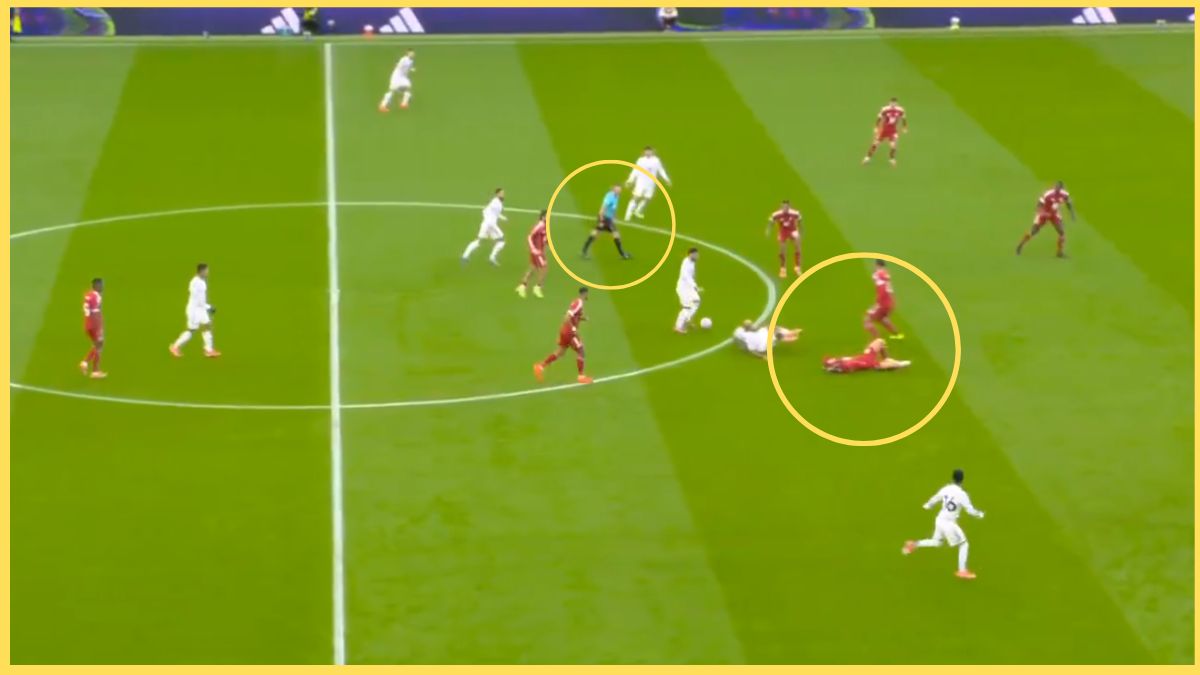 Alexis Mac Allister on the floor as Michael Oliver runs past.