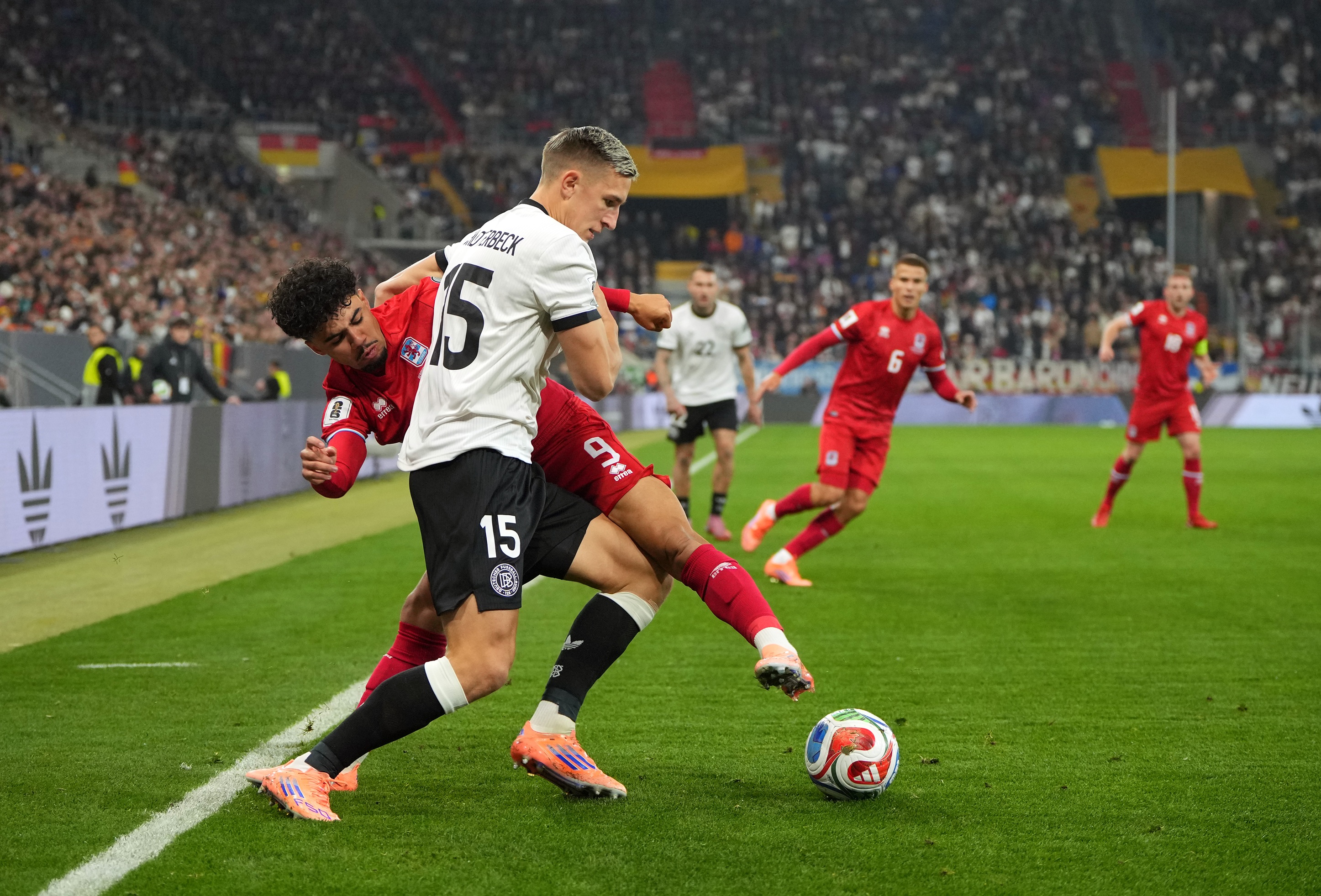 Nico Schlotterbeck grapples with Aiman Dardari of Luxembourg.