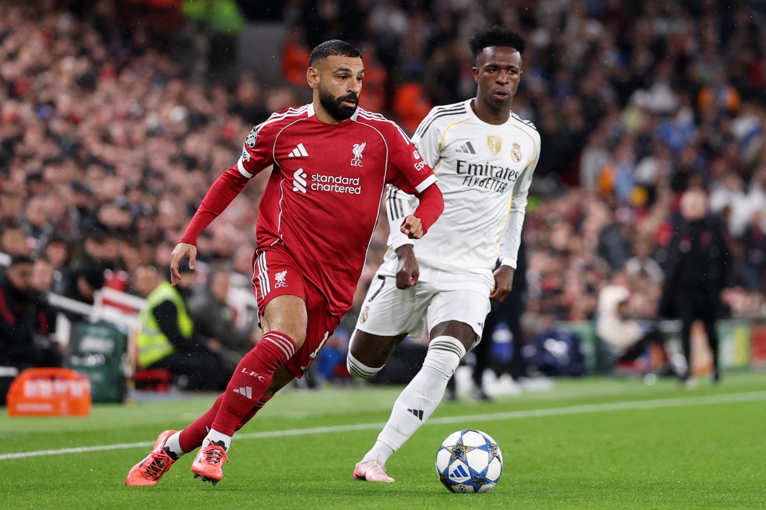 Mohamed Salah of Liverpool breaks away from Vinicius Junior of Real Madrid