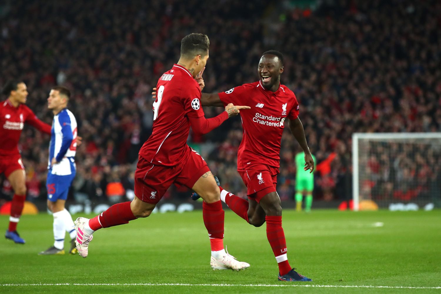 Naby Keita celebrates with Bobby Firmino in 2019