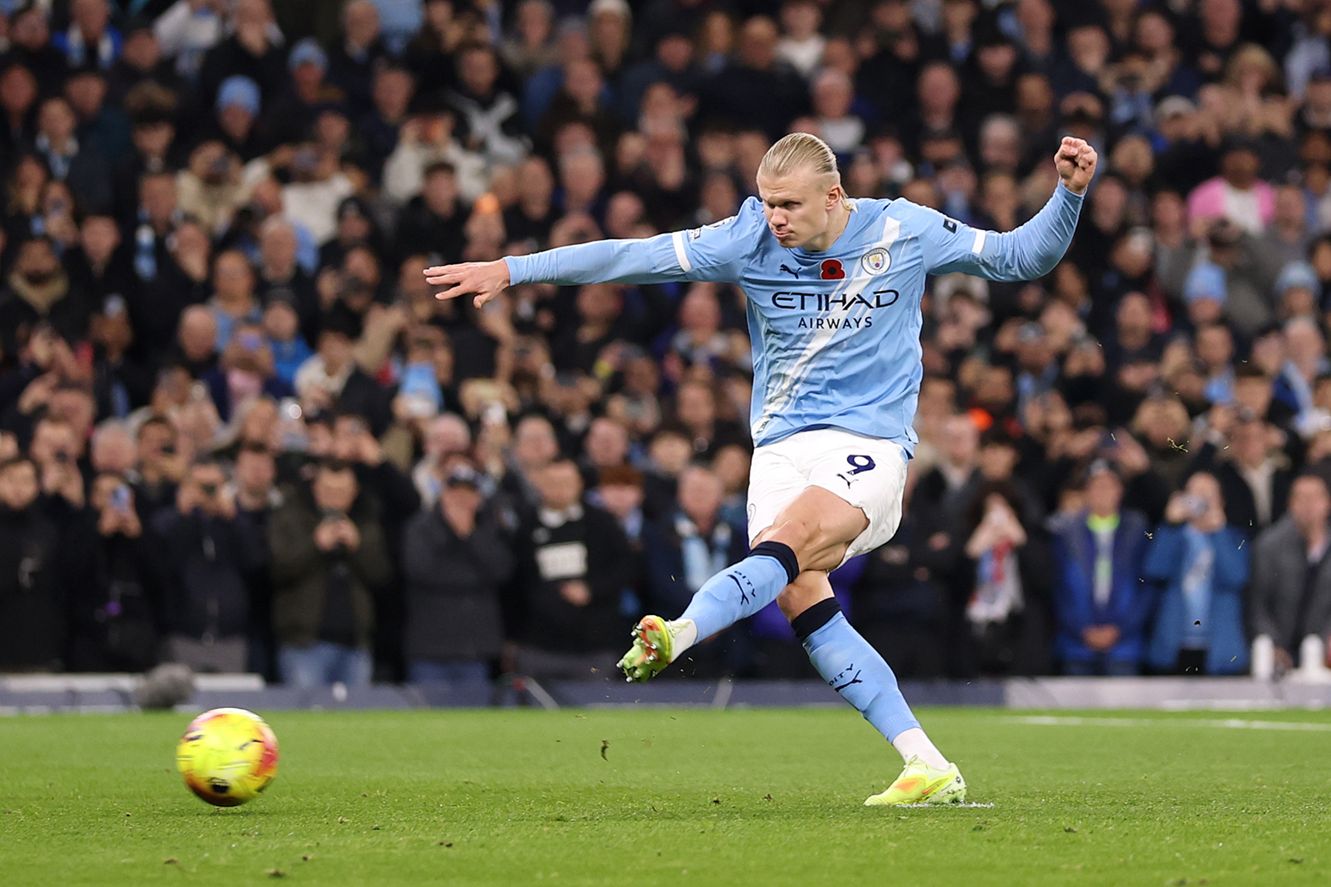 Erling Haaland takes a penalty kick against Liverpool.