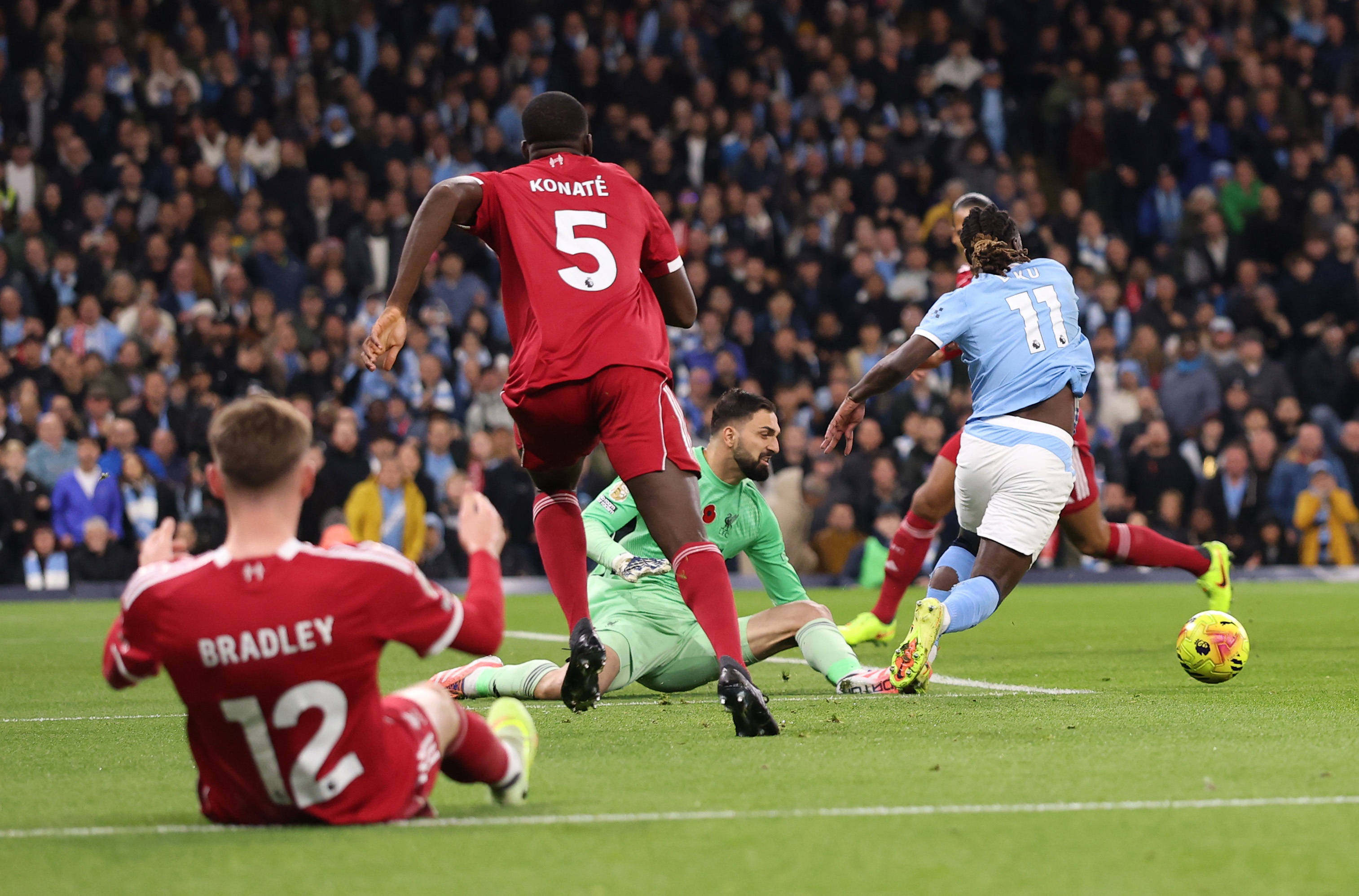 Giorgi Mamardashvili catches Jeremy Doku at the Etihad.
