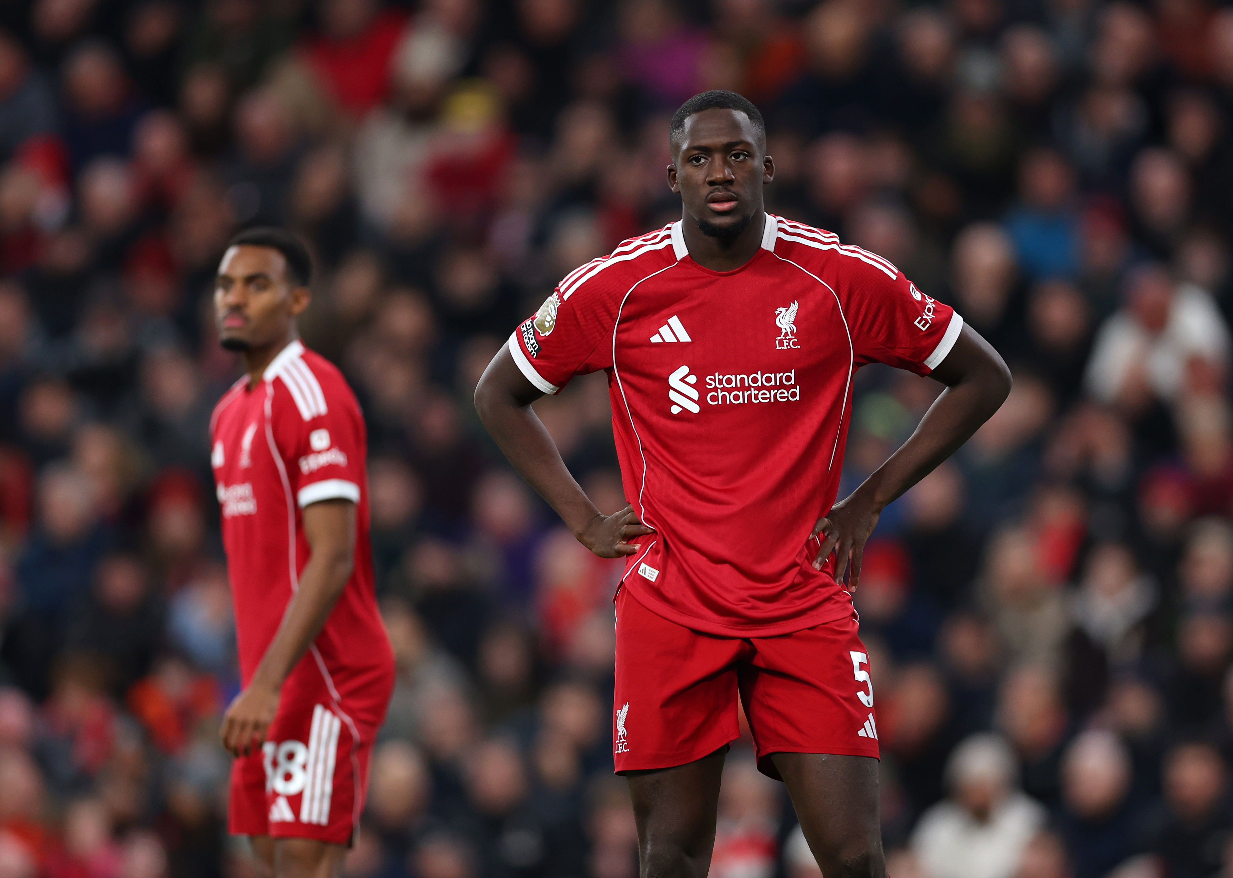 Ibrahima Konate stands with his hands on his hips during Liverpool game.