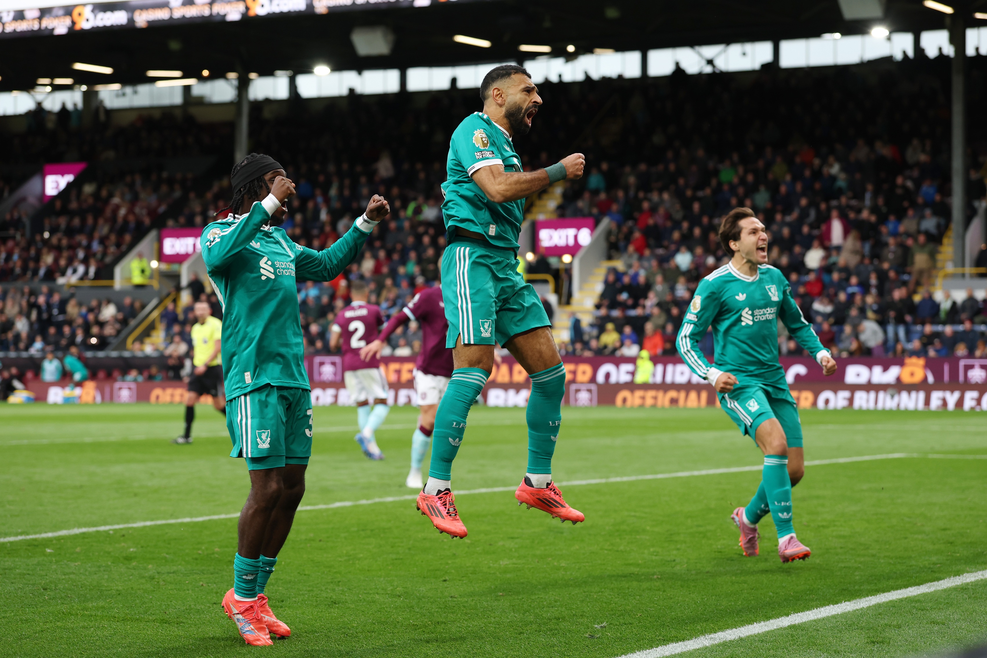 Jeremie Frimpong celebrates with Mo Salah and Federico Chiesa.