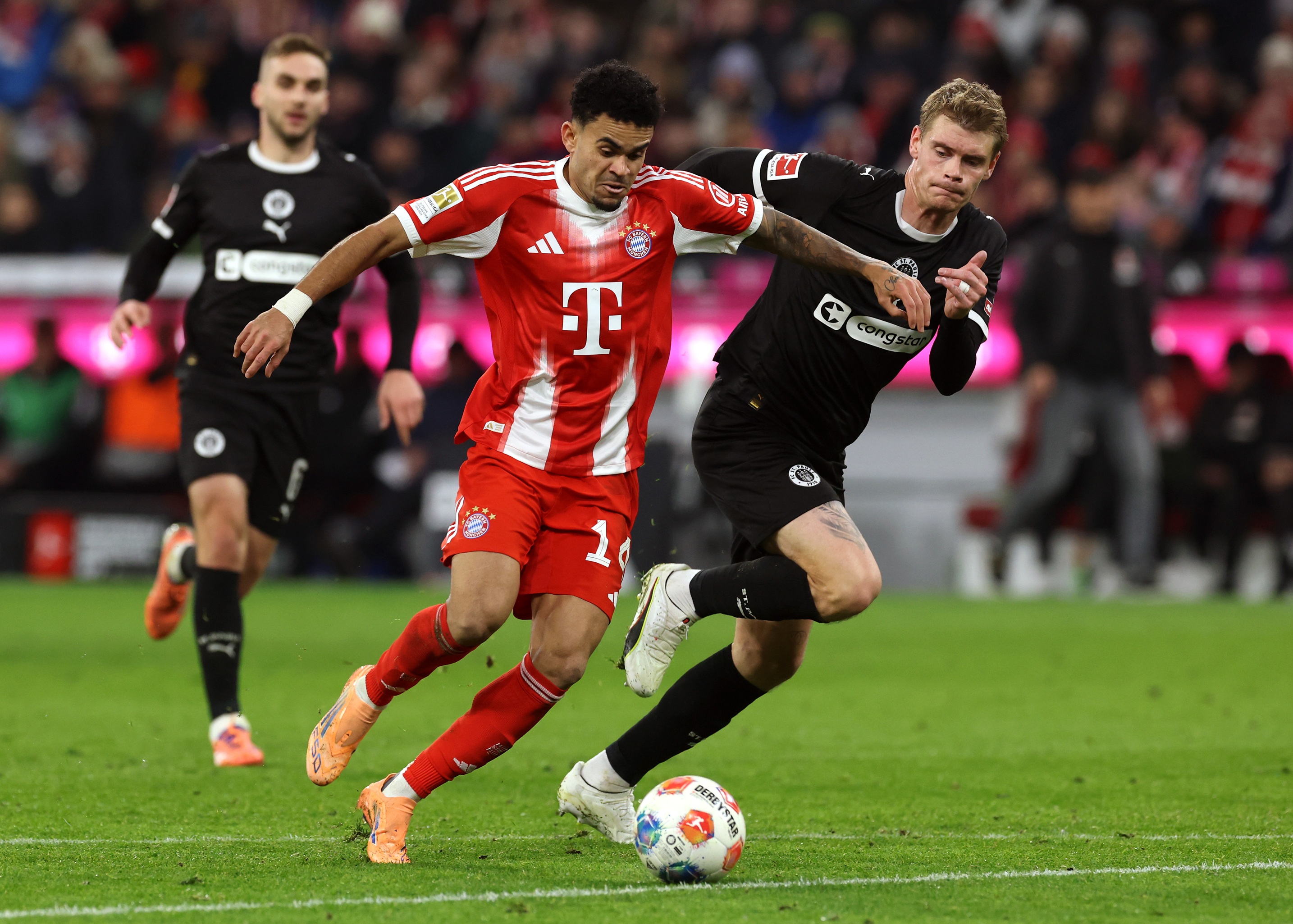 Luis Diaz dribbles with the ball while under pressure from St Pauli player.