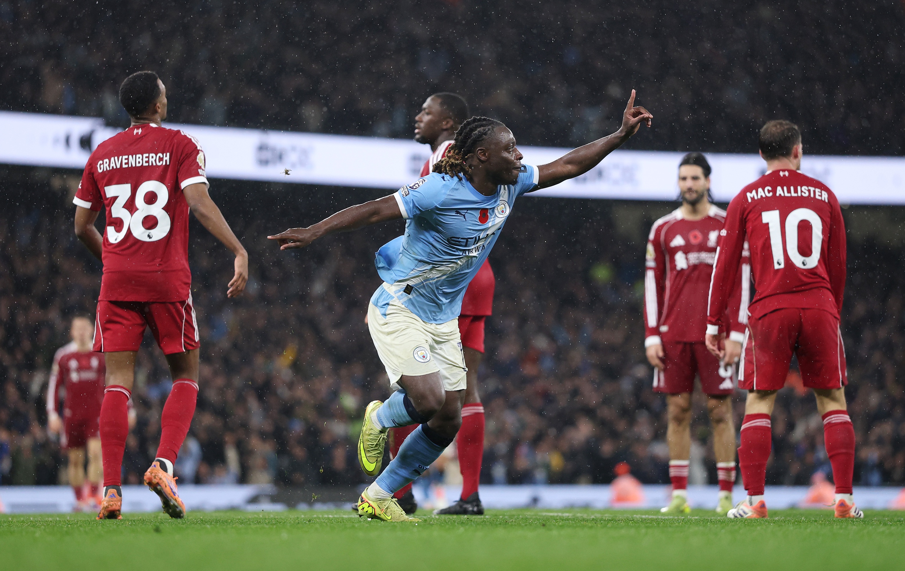 Jeremy Doku celebrates after scoring a goal against Liverpool.