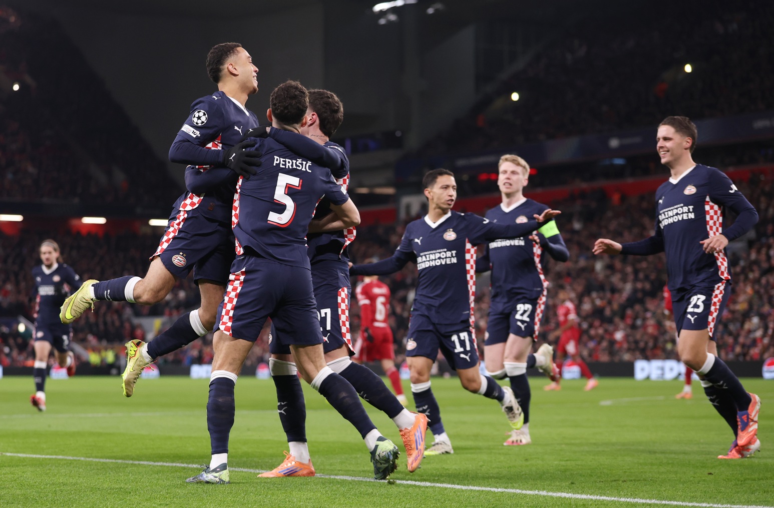 PSV Eindhoven players celebrate one of their four goals at Anfield