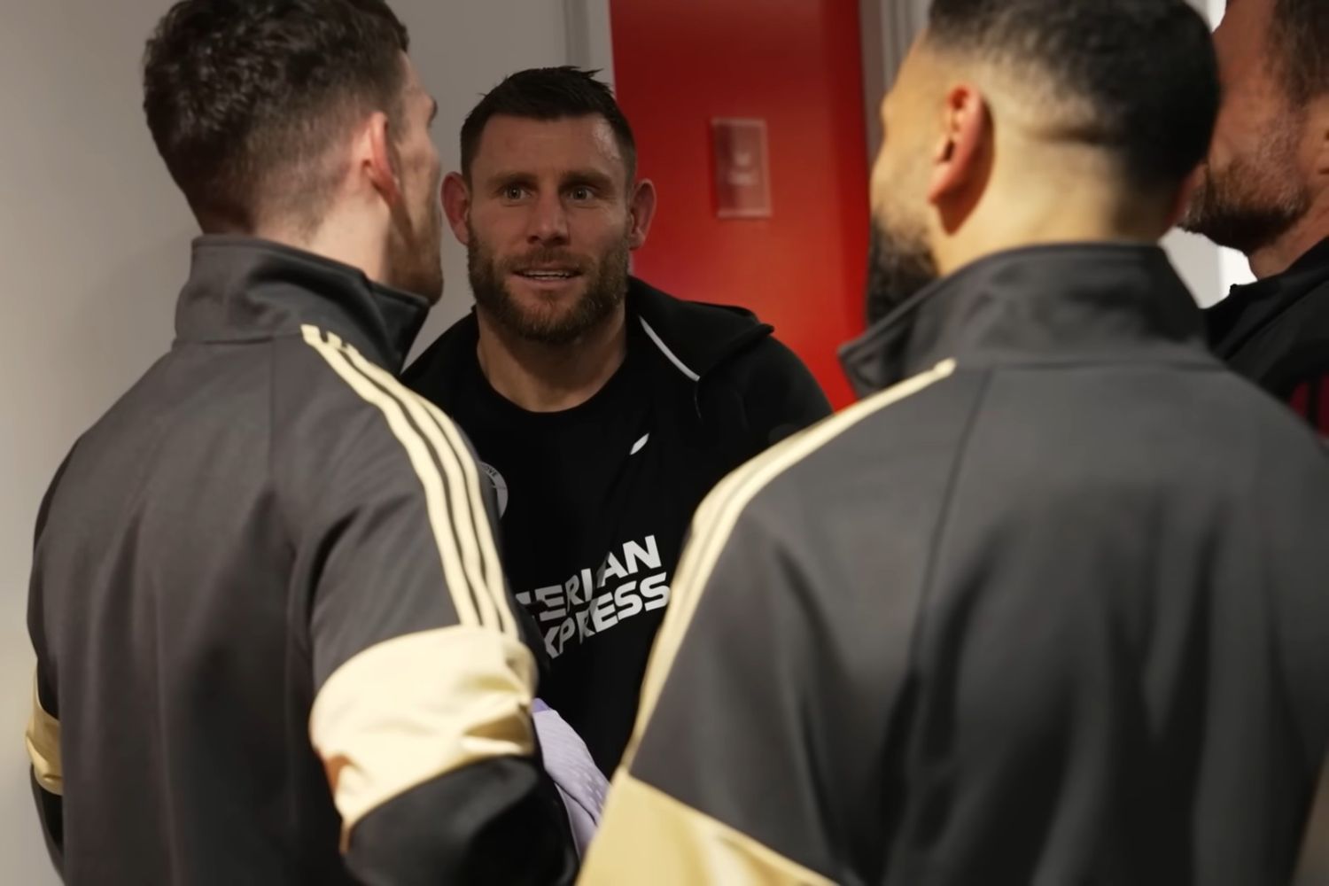 James Milner speaks with Mo Salah and Andy Robertson