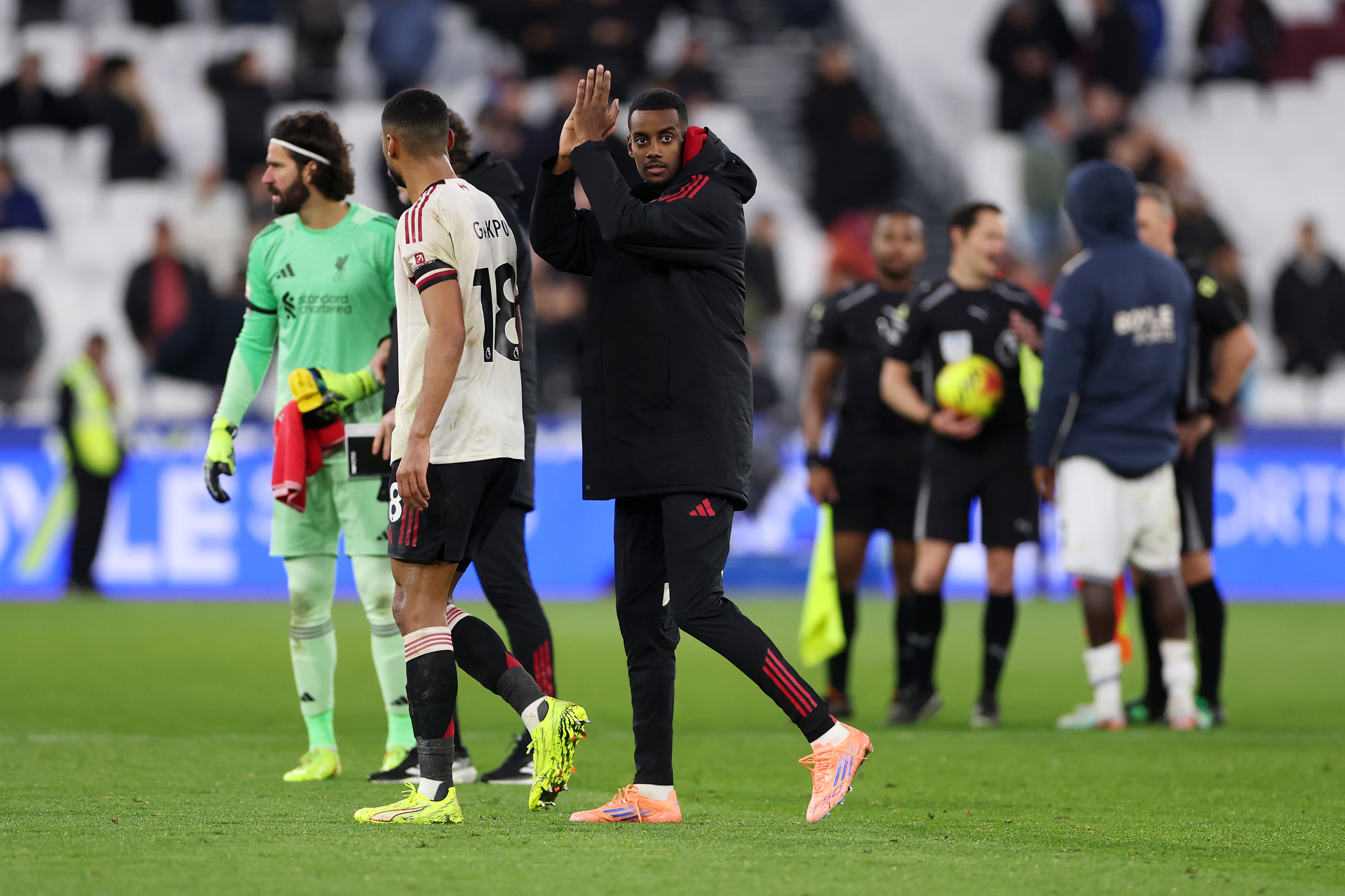 Alexander Isak claps the fans on the pitch.