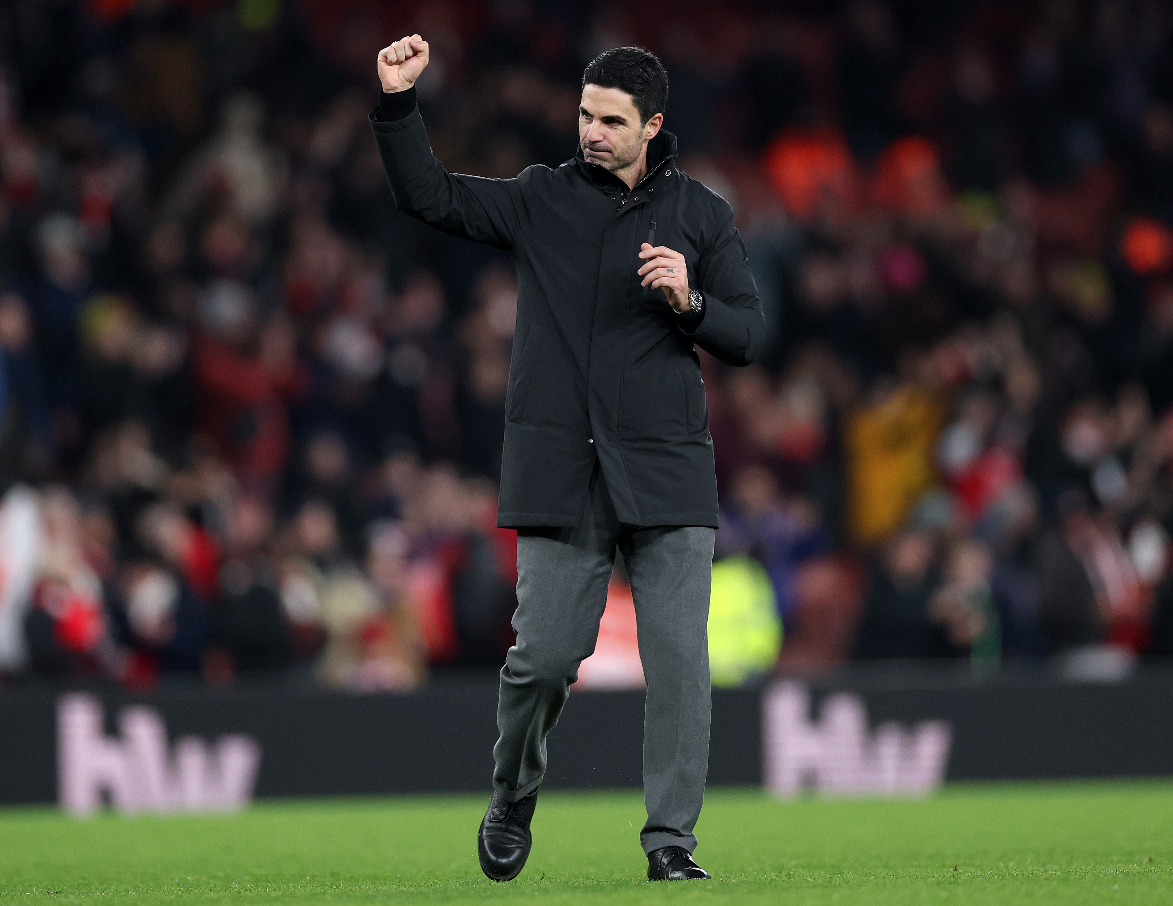 Mikel Arteta punches the air in celebration.