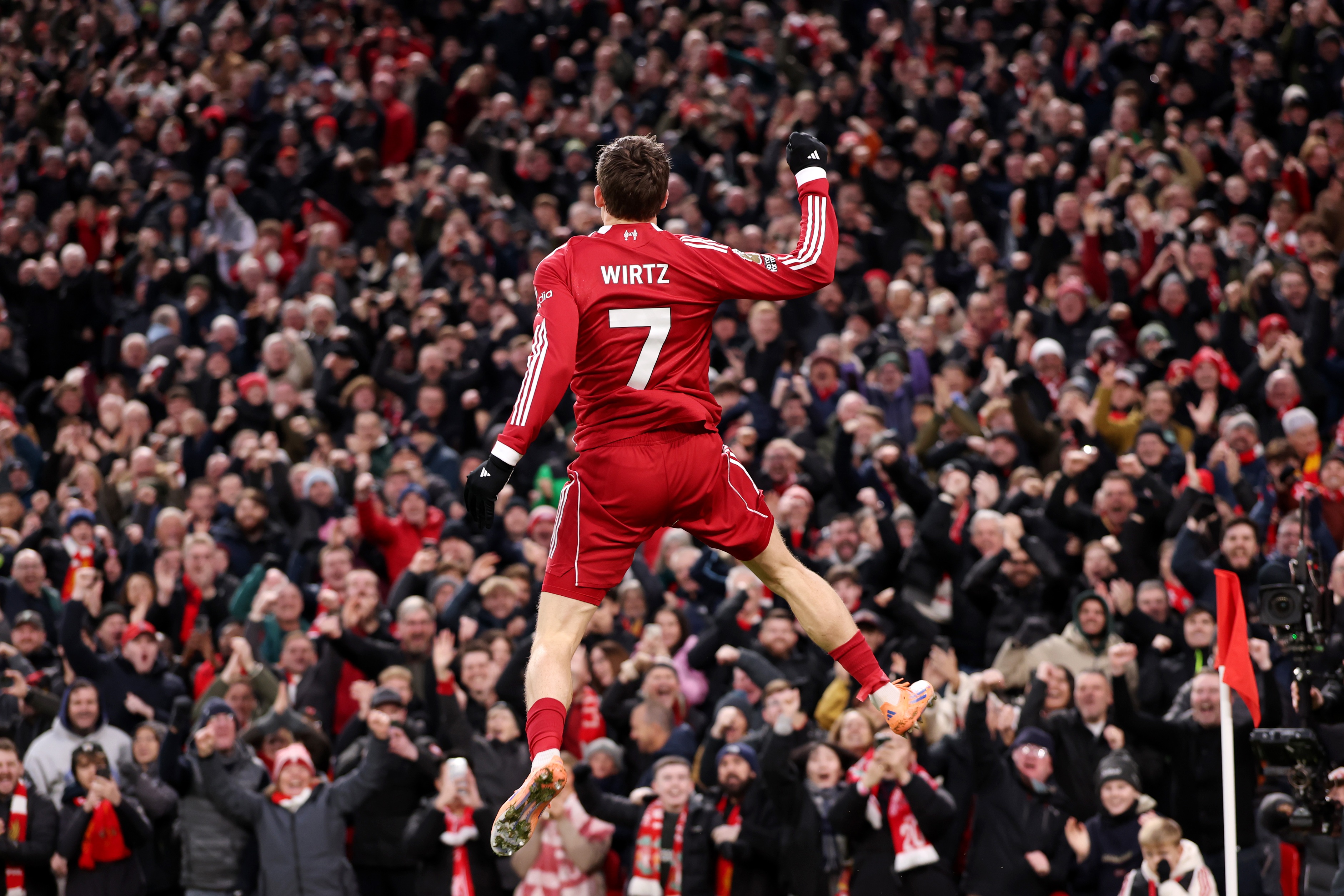 Florian Wirtz jumps in the air in celebration.