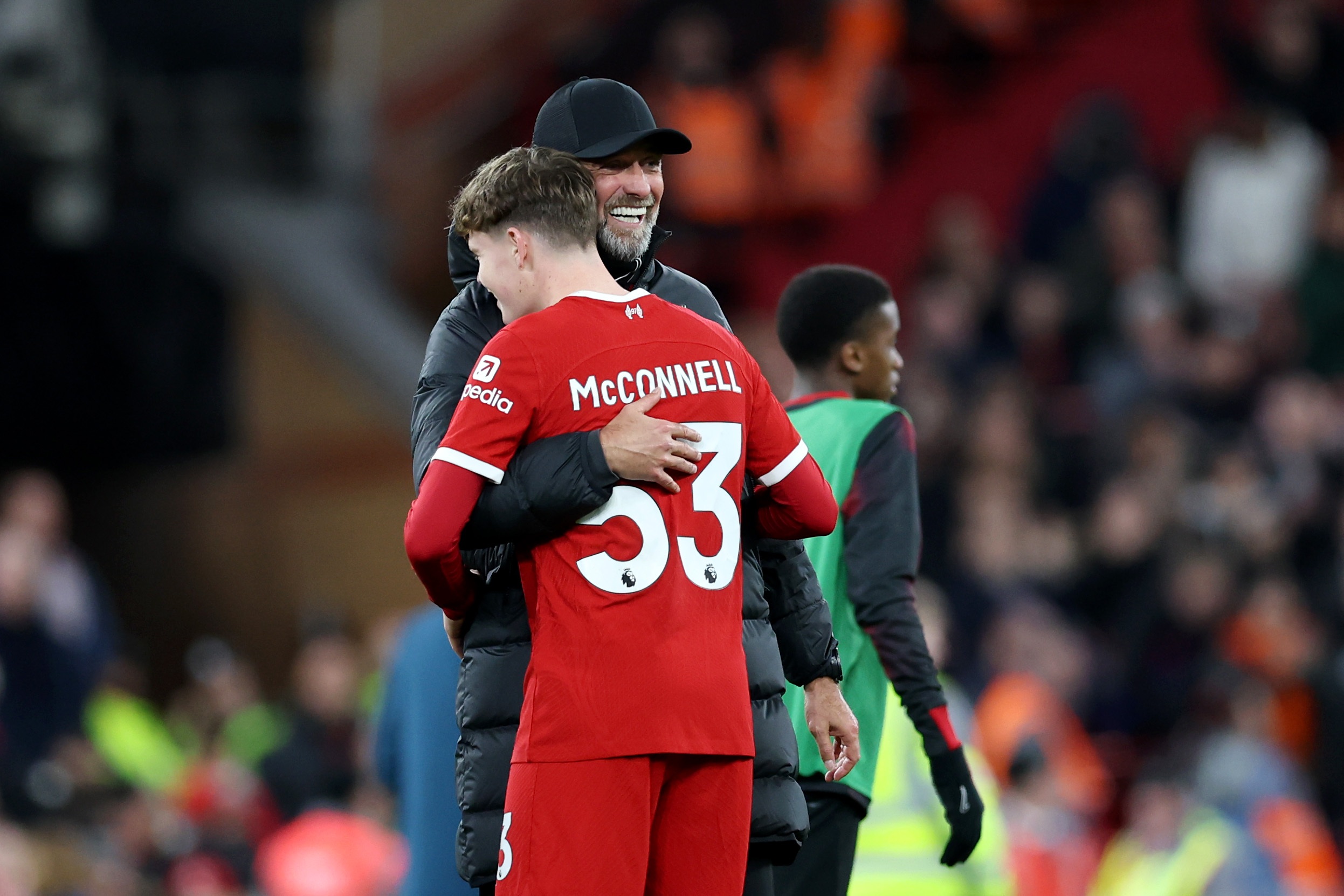 James McConnell hugs Jurgen Klopp on the touchline.