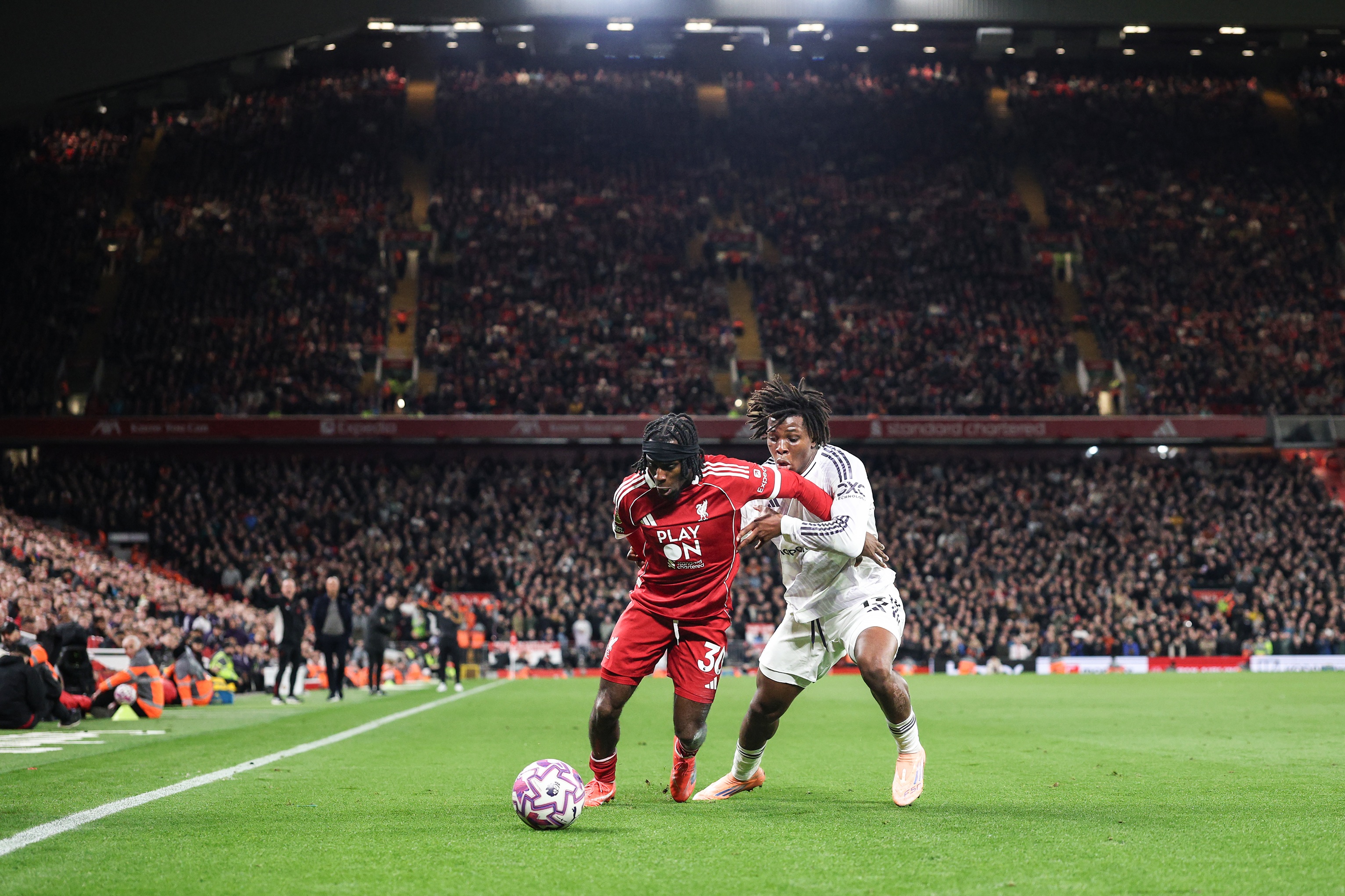 Jeremie Frimpong holds off Patrick Dorgu during Liverpool game.