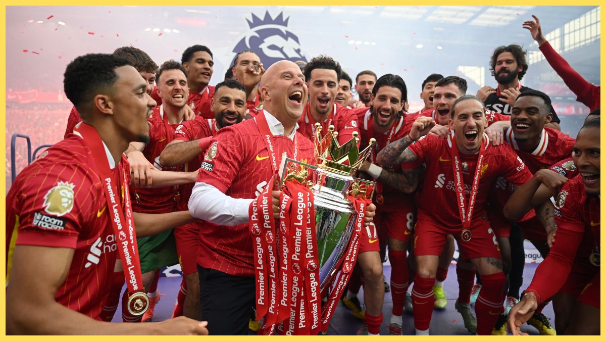 Arne Slot lifts the Premier League trophy with Liverpool players.
