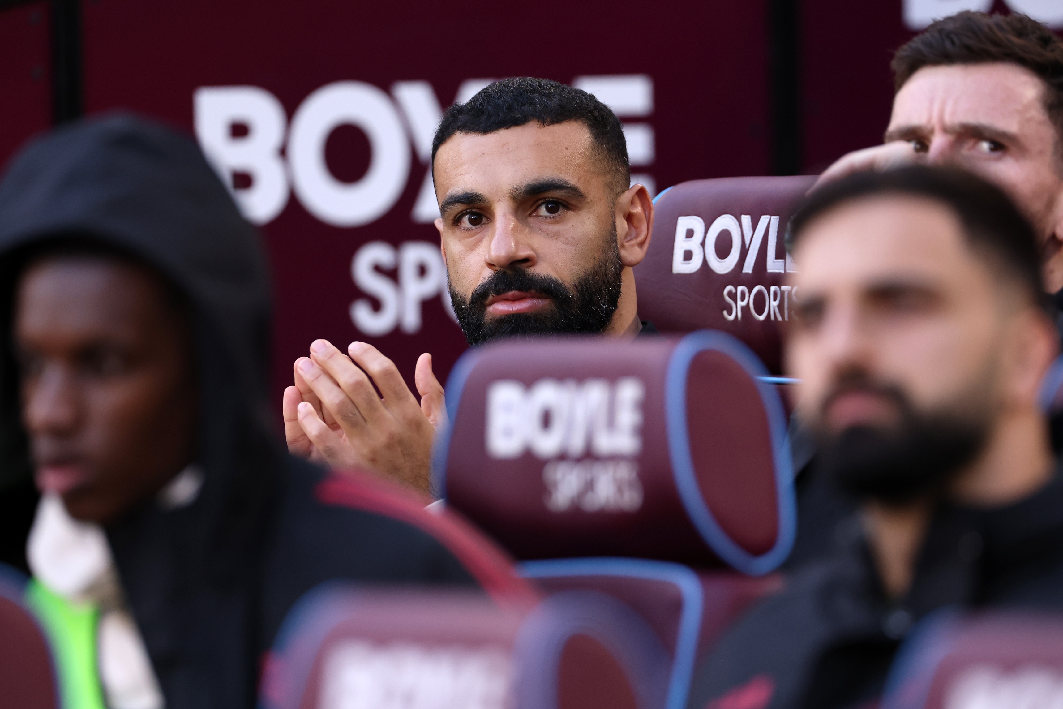 Mo Salah looks on from the bench during Liverpool game.