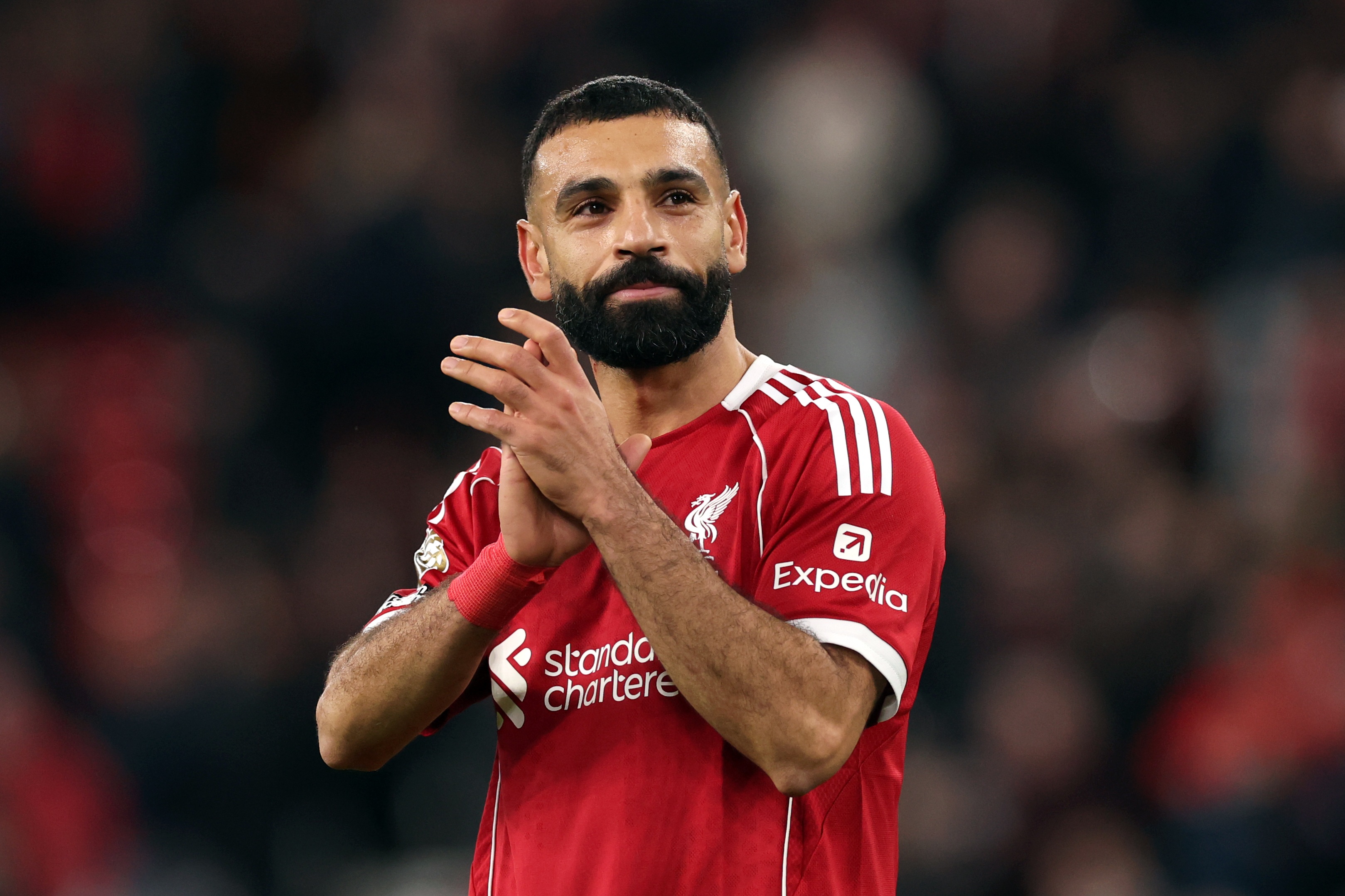 Mo Salah claps Liverpool fans at Anfield.