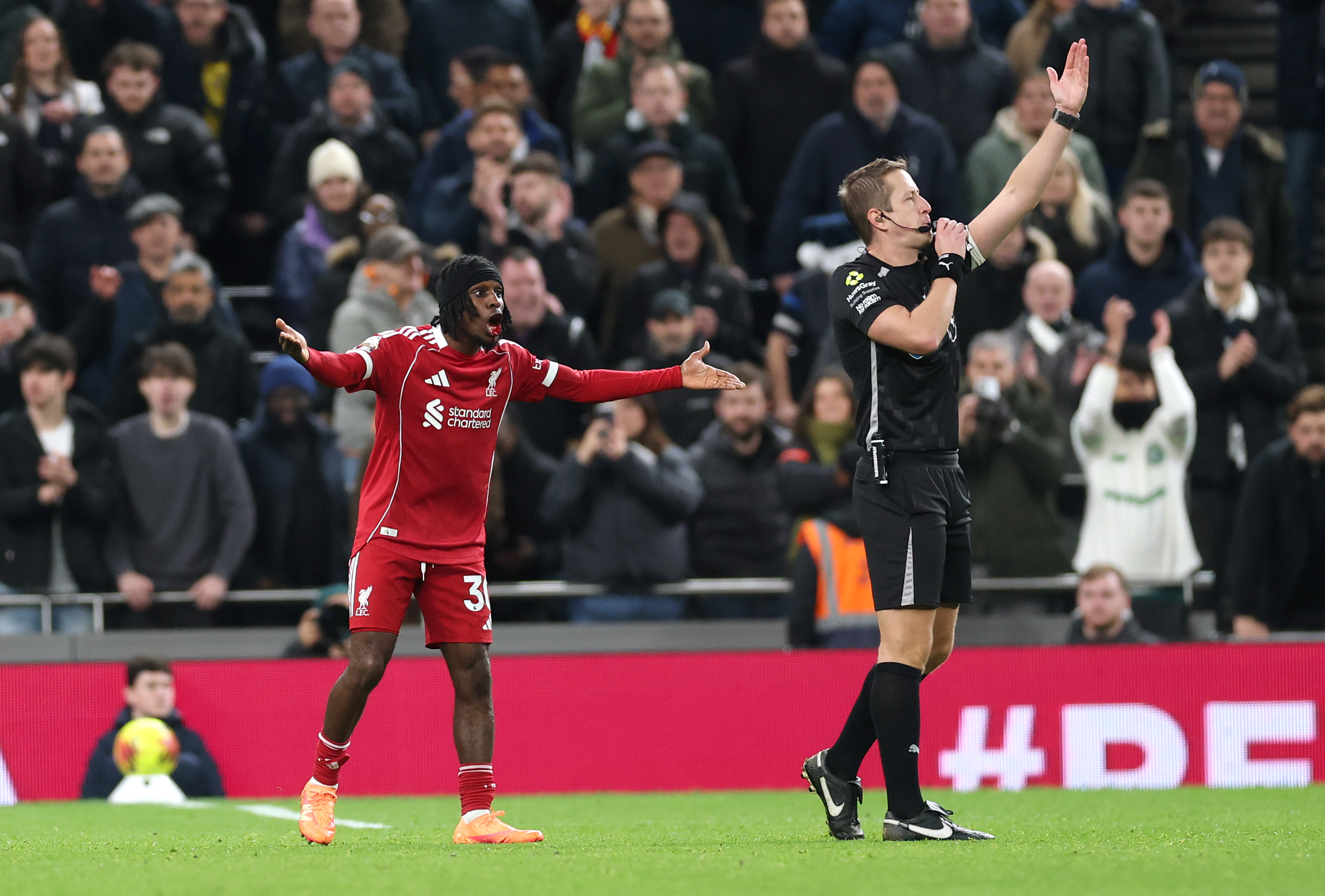 Jeremie Frimpong protests to John Brooks after being caught by a stray arm from Richarlison
