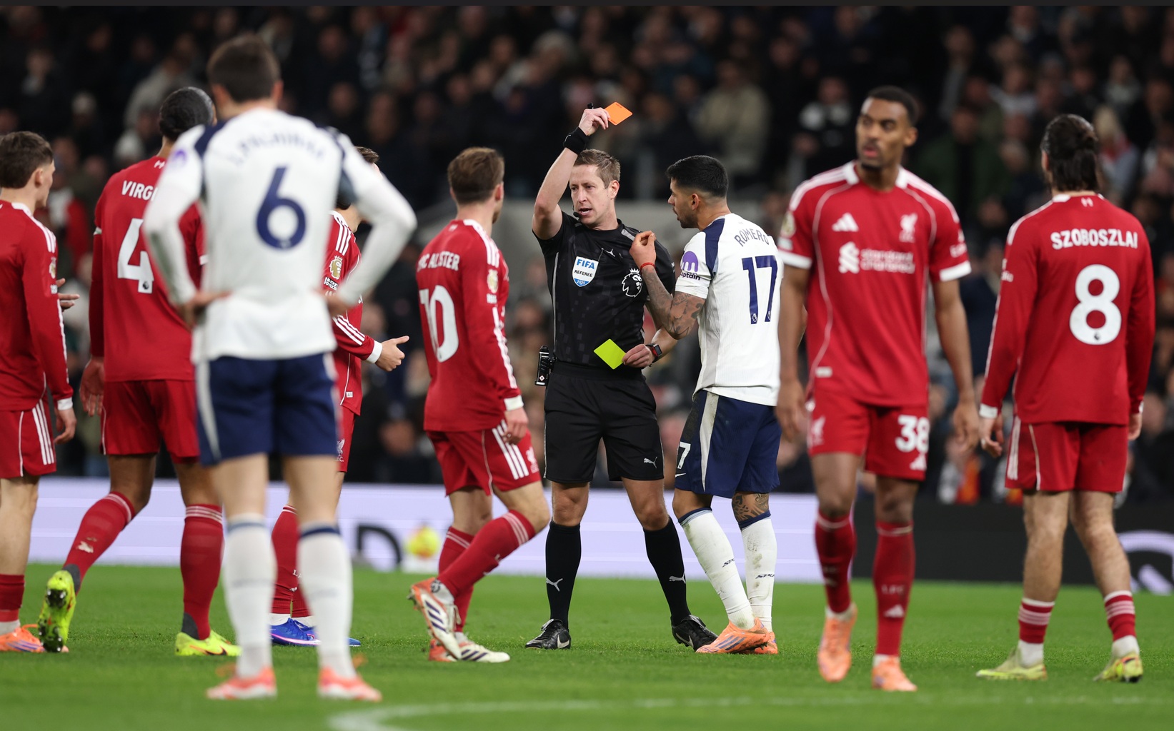 John Brooks shows a red card to Cristian Romero in Spurs' 2-1 defeat to Liverpool