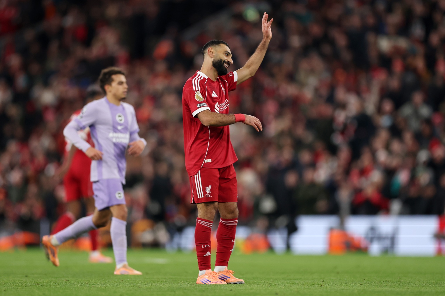 Mo Salah salutes Liverpool supporters during the 2-0 win over Brighton on Saturday