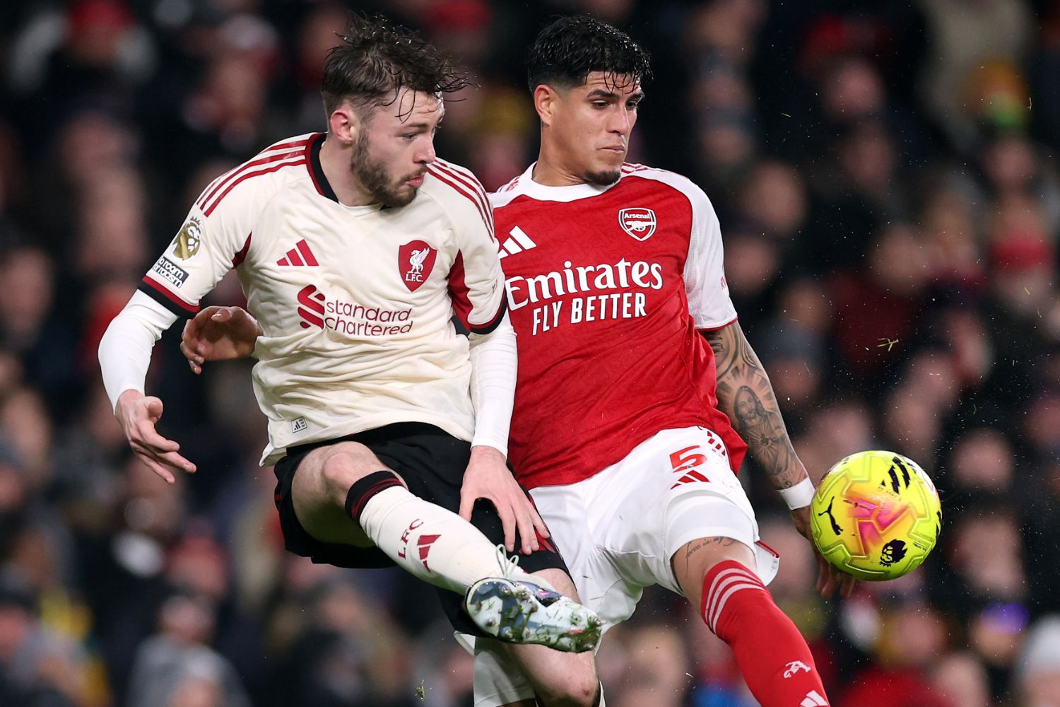 Conor Bradley of Liverpool jumps for the ball with Piero Hincapie of Arsenal