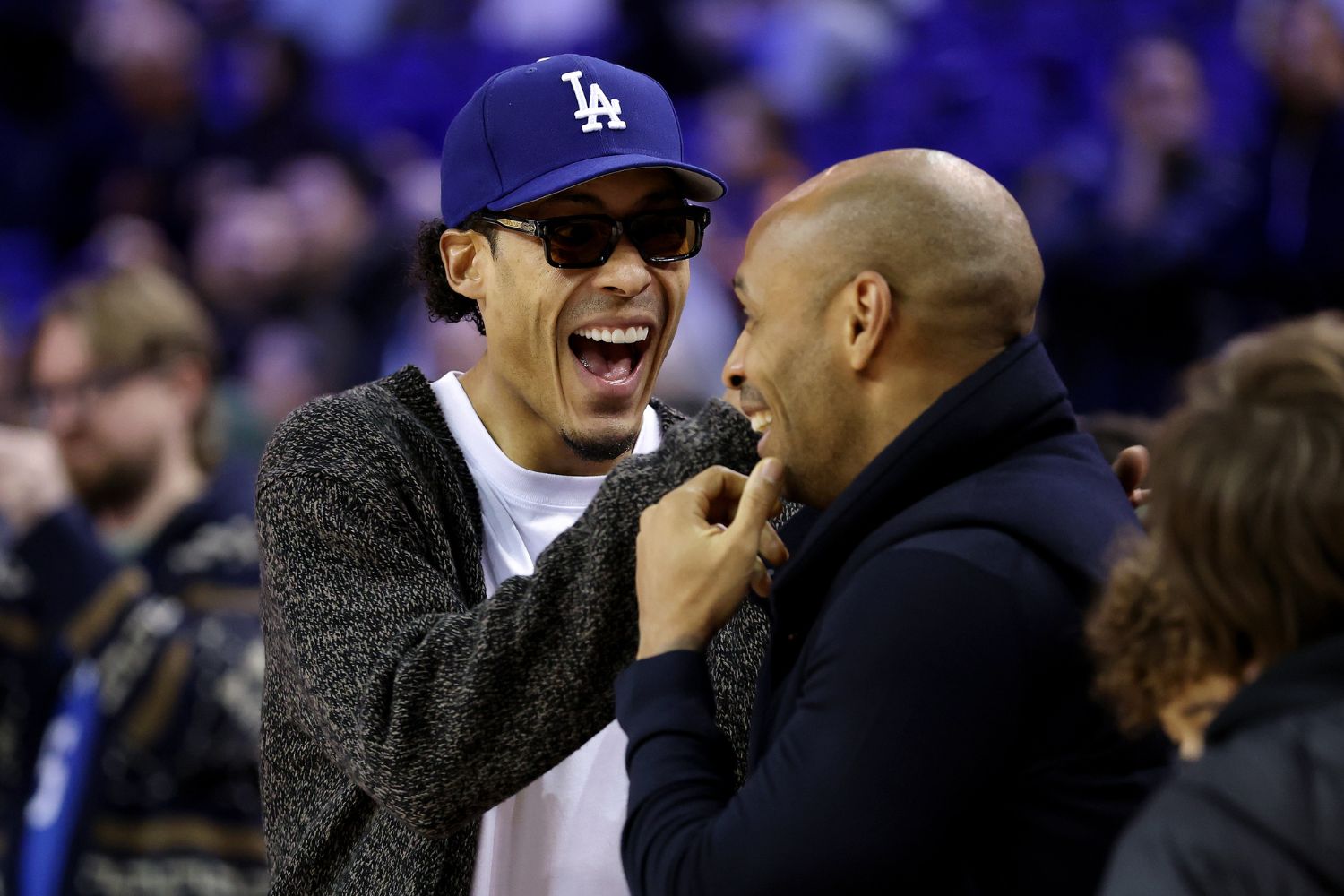 Virgil van Dijk speaks with Former Professional Footballer and TV Pundit, Thierry Henry prior to the NBA Match between Orlando Magic and Memphis Grizzlies at The O2 Arena